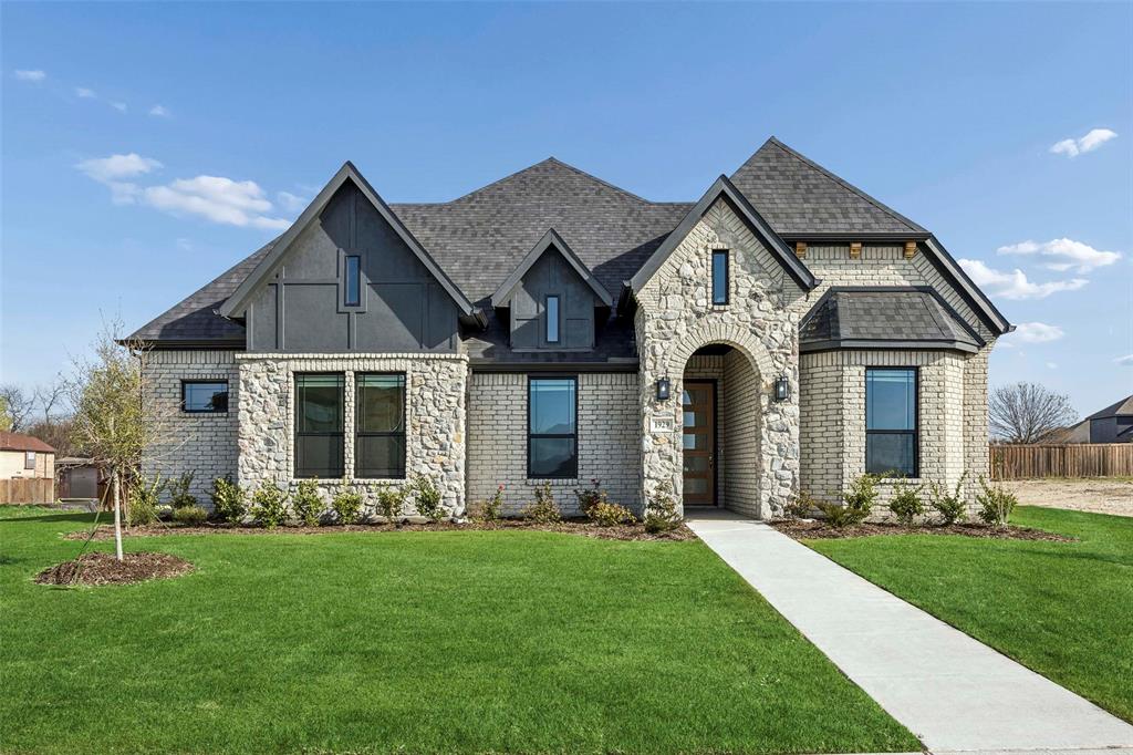 Special Financing with Lillian Homes! (see builder & lender for full APR and disclosure terms).  Nestled in the highly desirable Ten Mile Creek Estates of DeSoto, this stunning Lillian Custom Home perfectly blends modern luxury with energy-efficient living. From the moment you step into the grand 25-foot foyer, you are greeted by an expansive open-concept layout featuring durable luxury vinyl plank (LVP) flooring and elegant formal dining. The heart of the home is an upgraded luxury kitchen, showcasing crisp white cabinetry accented by chic gold hardware. The living area serves as an ideal gathering spot, complete with a cozy electric fireplace and pre-wired surround sound speakers for an immersive media experience. The primary suite is a true sanctuary designed for relaxation, boasting dual vanities, a stand-alone tub, and a massive extended separate shower alongside a generous walk-in closet. With 4 spacious bedrooms, 3 sophisticated baths, and a 3-car garage, there is no shortage of space. Outdoor living is equally impressive, featuring both a covered front porch and a back patio, all maintained by a full sprinkler system. Built with a commitment to quality, the home includes spray foam insulation and a comprehensive smart home system. Be sure to ask about available lender incentives and Hometown Hero specials for police, firefighters, and medical professionals!