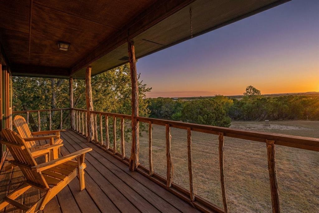 Escape to the peace and beauty of Somervell Country with this unique 35-acre AG-exempt property, perfectly situated at the gateway to Texas’ most scenic region. Only 90 minutes from DFW. Tucked away at the back of the property and unseen from the road, this charming ranch estate offers the ideal balance between secluded weekend getaway and comfortable full-time country living.
The spacious main ranch home features inviting natural wood and cedar siding, creating a warm rustic aesthetic that blends beautifully with the surrounding landscape. Inside, the open-concept kitchen and dining area centers around a striking rock fireplace and flows into a cozy living room and separate TV room—perfect for family gatherings. Custom built-ins and ample storage provide both function and character throughout. Three large bedrooms in main home with en-suite bathrooms and walk-in closets.
Attached to the main residence is a charming older cottage, offering two additional bedrooms, a large game room, full kitchen, walk-in pantry, and utility room—an ideal setup for extended family or guests.
Outdoors, you’ll find a separate bakery—a dream space for baking enthusiasts or a versatile homestead workshop for soap-making, canning, or crafts. The enclosed spa room with hot tub invites you to relax and unwind after a productive day.
For those who love the land, the master gardener’s vegetable and herb garden is a true highlight, showcasing the property’s self-sufficient potential.
Additional features include:
• Workshop with power
• Pole barn for farm equipment
• Insulated 4-car pull-through garage
• Spacious gazebo perfect for entertaining
• Shooting range and skeet station
• Abundant wildlife with over 120 recorded bird species
A true Hill Country hideaway, this property combines rustic charm, self-sustaining and endless recreation opportunities—all within reach of modern conveniences. Low Property taxes and in the acclaimed Glen Rose Independent School District.