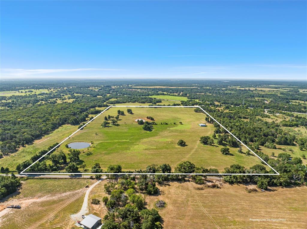 Motivated seller! Bring all offers! This remarkable 50-acre parcel of land offers a unique opportunity for your dream rural escape.  Here you will find a harmonious blend of natural beauty and functional features, making it an ideal canvas for various endeavors.  Mature trees throughout the property.  Whether you envision building your dream home, setting up a ranch, or creating a private retreat, this expansive land offers endless possibilities.  Perimeter is fenced and cross fenced. Good coastal on property.  Ag Exempt. Water at the road. Will need meter.