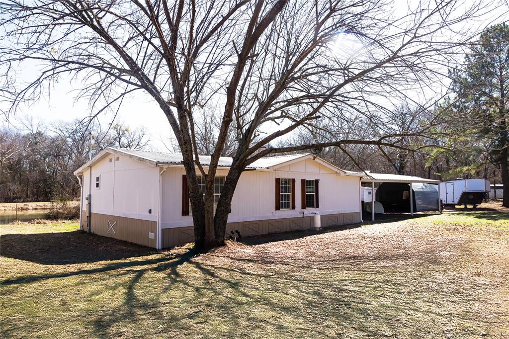 Enjoy peaceful country living with this 2 bedroom, 2 bath manufactured home situated on 2.23 acres, featuring a private pond with turtles and bass. Deer have been seen on tge property. There are rose bushes on the front gate. Property also has fruit trees. Surrounded by open space and natural beauty, this property offers the perfect blend of tranquility and convenience. Located in the Sam Rayburn ISD and just minutes from multiple lakes, it is ideal for outdoor enthusiasts who enjoy fishing, boating and quiet evenings under the stars. With ample room for animals, gardening or future improvements, this property offers endless possibilities.  Stove operates with propane.  Property features a workshop with screened porch. Buyer and or buyer's agent to verify any and all information. MOTIVATED SELLERS! Home selling as-is.