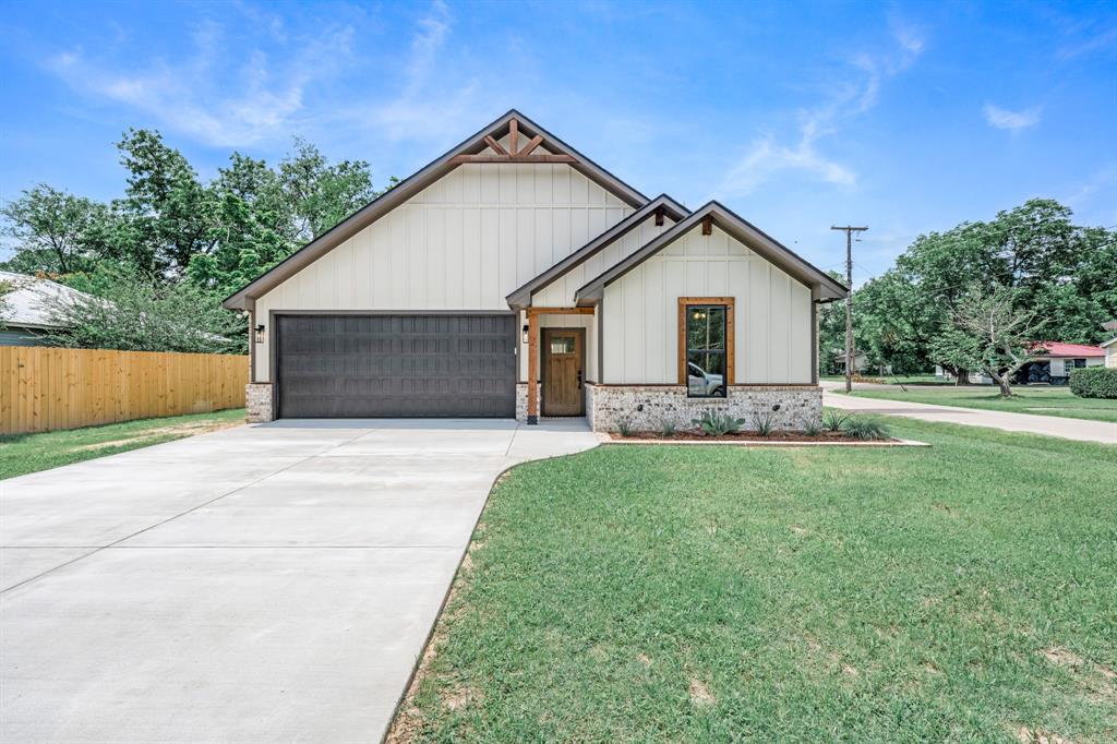 Gorgeous custom-built 2026 home in the heart of Mineola! This beautiful brick home features 3 bedrooms, 2 bathrooms, and an attached 22' x 20' garage, and sits on a corner lot.  The open-concept floor plan offers exceptional style and functionality, showcasing custom cabinetry with under-cabinet lighting, a large quartz island, coffee bar, brand-new Frigidaire appliances, and a walk-in pantry. The primary suite includes a custom walk-in closet and an ensuite bath featuring a tub and shower combination, double-sink vanity, and ample cabinet storage. Designed with quality and comfort in mind, this home comes with numerous high-end upgrades, including enhanced insulation throughout, upgraded wall texture, luxury vinyl flooring, crown molding, and decorative lighting. Approximately 570 square feet of well-insulated and sprayed foam attic space provides excellent storage and temperature control. Outside, you'll find front landscaping, a partial privacy fence, and a 21' x 10' patio perfect for entertaining or relaxing and an additional driveway that could be used for boat parking, etc.  Conveniently located near shopping, restaurants, and downtown Mineola, this move-in-ready home offers the perfect blend of modern amenities and small-town charm.