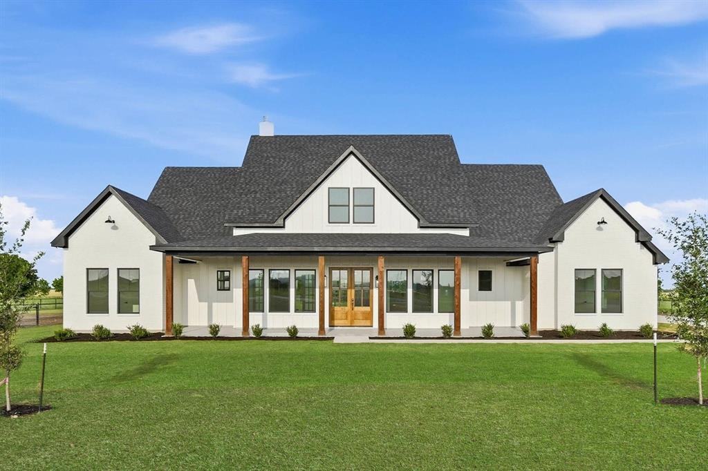 Situated on two beautifully appointed acres, this exceptional custom residence blends sophisticated design, luxury finishes and the tranquility of country living. Step inside the experience soaring 10-foot ceilings throughout the home complimented by a dramatic 16-foot ceiling in the main living area and an impressive 16-foot floor to ceiling stone fireplace that serves as the heart of the home. The designer kitchen is a true showcase of craftsmanship and refinement, featuring custom ceiling-height white oak cabinetry, stunning Taj Mahal quartzite countertops and full height backlash, and premium ZLINE luxury appliances. Every detail has been carefully selected. High end Delta fixtures enhance it's sophisticated design. The spa inspired bathrooms continue the home's elevated aesthetic with ceiling height Taj Mahal tile surrounds, while the luxurious primary suite features oversized porcelain tile. Perfect for upscale entertaining, the expansive living area extends outdoors through a wall to wall sliding glass door that open to an oversized covered patio complete with epoxy flooring and beautiful outdoor fireplace creating the indoor, outdoor living experience year round.
* Foundation has 36 concrete pierce, strategically placed in order to prevent future foundation problems.
The front oversized porch additional space to unwind. This beautiful residence offers Elegant living with endless possibilities!