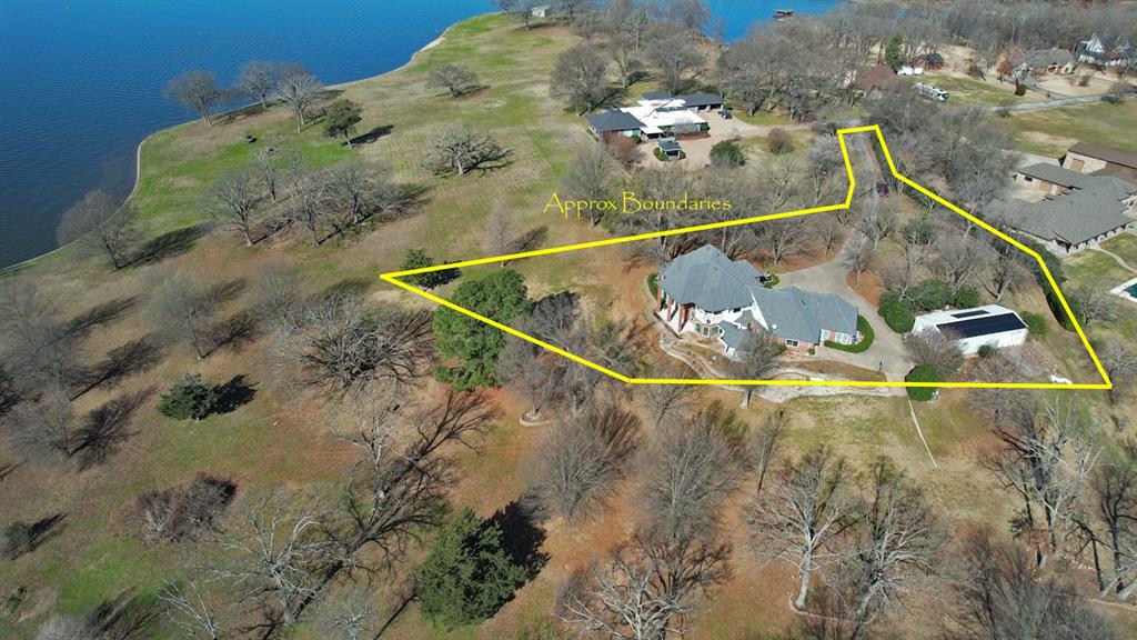 Indulge in the pinnacle of Lake Fork living with this extraordinary waterfront estate, boasting what is arguably the most breathtaking waterview on the entire lake. Don't just take my word for it—come witness the unparalleled beauty for yourself. This stunning home comprises 3817 SF of living space, with 600 SF dedicated to a full private apartment, complete with ADA-compliant doorways, and a private entrance, ideal for older parents, young adults, or renters. The approx. 780 ft of pristine shoreline, framed by a newly constructed retaining wall and a covered dock, ensures effortless pleasure on Lake Fork's renowned waters. Inside…discover an open-concept floor plan, the kitchen seamlessly flows into the living area, adorned with a gas fireplace and a soaring two-story ceiling, framing picturesque views of the lake. The kitchen features two islands, a built-in desk, and a spectacular breakfast nook surrounded by panoramic lake views. Every room boasts stunning vistas. The master exudes comfort and luxury with its gas fireplace, spacious ensuite bathroom with jetted tub and walk-in shower, and separate closets. Also downstairs, a study awaits. Upstairs, two additional bedrooms, a game room plus a balcony offer additional space for relaxation and entertainment. A portion of the attic has been converted into a hobby room, providing approx. 300 SF of bonus living space. Outside, find a detached 2,000 SF metal building for whatever purpose. Solar panels atop the outbuilding contribute to the home's power system, enhanced by a whole-house generator for added peace of mind. Nestled at the end of a peninsula…this home offers unparalleled privacy. Situated just off FM 515, you're close to all the amenities you need, from world-class fishing on Lake Fork to golfing at the famous Links at Land's End. Embrace a lifestyle like no other, just 90 miles east of DFW and 60 miles from Tyler. Discover what others have been enjoying for years—the epitome of Lake Fork luxury awaits.