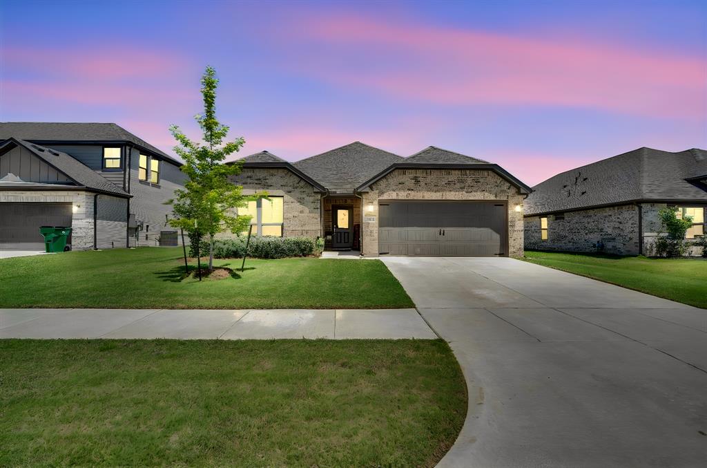Step into this stunning three-bedroom, two-bath home thoughtfully crafted for comfort and style. As you enter, you are greeted by two inviting secondary bedrooms and a full bath. Continue down the hallway to discover a bright, open-concept living, dining, and kitchen area filled with natural light and views of the backyard. The kitchen is a chef’s delight, featuring a breakfast bar, gas range, natural stone countertops, a spacious pantry, and abundant storage. Just off the kitchen, a cozy nook with a built-in desk leads to a generous utility room. The primary bedroom, tucked to the left of the living area, offers a private retreat with an ensuite bathroom boasting an oversized shower, dual vanities, and a walk-in closet. Enjoy outdoor living in the fenced backyard with a covered patio and take advantage of the convenience of a two-car garage—this home truly has it all.