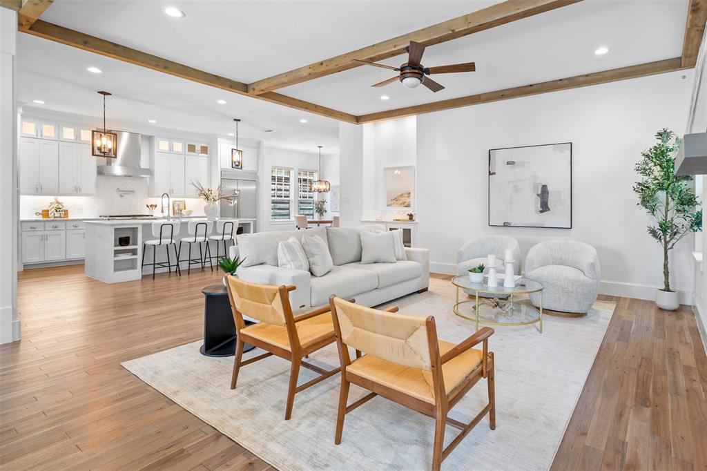 Built in 2018, this modern farmhouse offers 4 bedrooms, 3.5 baths, plus a huge bonus room. The home features a thoughtfully designed open floor plan. Soaring 11-foot ceilings on the main level and 10-foot ceilings upstairs fill every room with natural light, giving the interiors an airy, expansive feel. It's just minutes from all of the action near Lower Greenville and the M Streets. Tietze park is also nearby. The main level centers on a kitchen anchored by a large island, marble-quartz countertops, custom cabinetry, and stainless steel appliances including a double oven and gas range. Hardwood floors and designer tile carry throughout. The primary suite is on the main level, featuring his-and-hers walk-in closets, a freestanding soaking tub, and a dual walk-in shower. Upstairs, additional bedrooms and baths are joined by an oversized bonus room with a wet bar, that can have multi-purpose use. Spray foam insulation keeps energy costs low. The garage includes a 240V EV charging outlet and water softener, and a reverse osmosis system serves the kitchen. This home stands out as a rare modern farmhouse in one of Dallas’s most established neighborhoods.