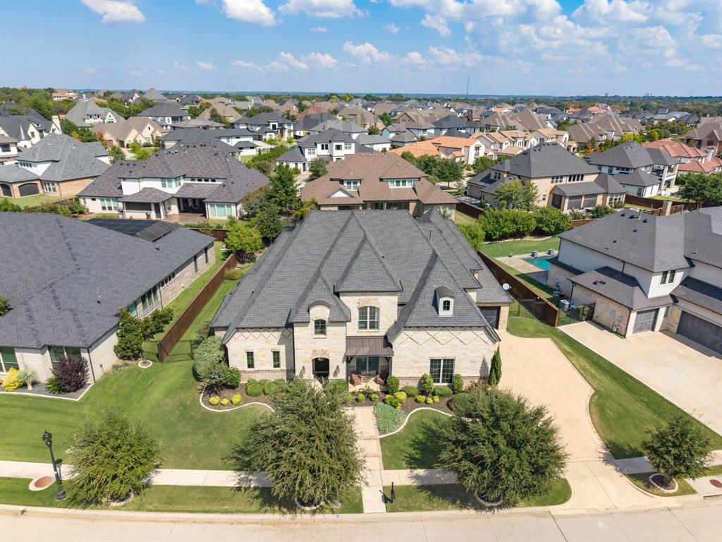 Welcome to an exceptional residence in the highly sought-after Lake Carillon community of Southlake.  This stunning home blends elegance, comfort, and functionality, offering a truly elevated living experience.  Step inside to discover a bright, open, and inviting floor plan designed for both everyday living and entertaining. Expansive living spaces flow seamlessly, filled with natural light and refined finishes throughout.  A standout feature is the impressive 1,000 bottle, temperature controlled wine room perfect for collectors and those who love to entertain in style.  The gourmet kitchen and main living space is open with beautiful vaulted ceilings with wood beams. The home also boasts a dedicated media room, creating the ideal space for movie nights, game days, or relaxing with family and friends.  Outdoors, you’ll find your own private paradise with a sparkling pool for summer fun with friends and family. The beautifully designed patio features a built-in grill and a cozy fireplace, making it the perfect setting for year-round gatherings or quiet evenings under the stars.  Located just minutes from award-winning Carroll Independent School District, as well as premier shopping and dining at Southlake Town Square and Central Market, this home offers both convenience and lifestyle.  Lake Carillon residents enjoy a vibrant community atmosphere with scenic lakes for fishing a nine acre park with play grounds and basketball courts woven in the heart of the neighborhood creating endless opportunities for outdoor recreation and connection.  This is more than a home it’s a place to live, relax, and thrive.   The secondary bedroom down is large enough as second owner in-law suite.  This location is just minutes from the main highway with easy access to DFW airport and both Dallas and Fort Worth.  This home offers it all do not miss out of this one.
