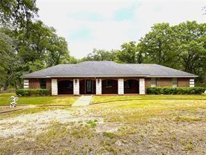 Country Stunner way off the road in a park like setting with a circular driveway with pipe and stone fencing.  Nice drive up appeal with a covered front porch, side entry attached garage, offering 3 bedrooms, 2.5 baths, 2 living areas one with a wood burning fireplace.  This gem has been recently renovated with a new roof, new HVAC, new quartz counter tops in the kitchen, new water heater, new interior paint, additional blown insulation in the attic and more!  Nice open back yard with tons of woods in the back acreage, and an open concrete patio to sit and view the nature!  There is a large frame building that can be easily converted into a guest quarters.  Prior owner used it as a dog grooming business.  It has electric, water, toilet and sinks and two large rooms or use it as an office away from the house!  Move in ready near the lake and in Quinlan ISD!