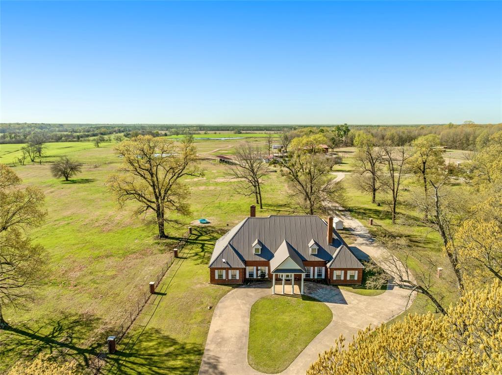 BEAUTIFUL EAST TEXAS CATTLE RANCH! This 527 acre ranch is a turn-key set up for a cattle rancher looking to expand. Located between Paris, Texas & Clarksville, TX, this property offers rich pastureland, fenced & cross-fenced for rotational grazing, 2 hay barns, pipe working pens, covered hydraulic chute, 7 holding-sorting pens with 4 holding-sorting pens with concrete water troughs, loading chute, grain bins, concrete feeders, lean-to for equipment, 30x60 metal building with 2 roll up doors, concrete floor & electricity. You'll also find a 6 stall horse barn with runs & round pen. Also included 188 cows & calves, with 122 cows under the age of 3. There's a custom 3,038 SF home with 3 bedrooms 2 baths & 2 half baths with spacious living area & large family style kitchen, formal dining room & office-formal LR. The primary suite is large with its own WBFP, jacuzzi tub, walk-in shower, double sinks & large walk-in closet. The other two bedrooms are good sized with nice closets + Jack & Jill bathroom. This property also includes a private gated entry that leads to the circle drive.