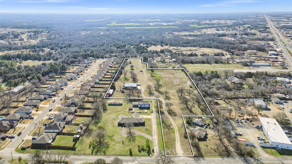 This 7.85-acre property offers endless possibilities with its unique mix of city and county zoning. A 2,400 square foot insulated shop, complete with electricity, serves as the centerpiece. It features a 14-foot awning on the side, entry doors on all four sides, a 14-foot roll-up door, and an 8-foot roll-up door on the front—perfect for accommodating large equipment or vehicles. The property includes one RV hookup, offering convenience for various uses. Current water supply comes from two 2,500-gallon tanks that collect rainwater from the shop roof, used to service the shop bathroom. City water available. With part of the property zoned for commercial use within the city limits and the remainder unzoned in the county, the potential is unmatched. Whether you envision single-family homes, multi-family residences, commercial development, or a combination of uses, there’s ample room for parking, storage, shop space, and office facilities. Located in Denison, this property offers an excellent opportunity to develop or expand your vision. Don’t miss out on this rare find!