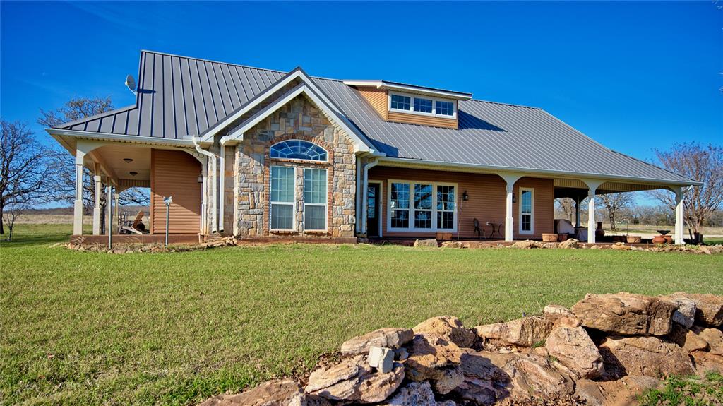 Experience wide open Texas living on this exceptional 55.652 acre property featuring a beautifully crafted 3 bedroom, 2 bath home with 2,036 sq ft of inviting living space. The interior offers soaring ceilings with cedar beam accents, a warm gas fireplace, and an open concept layout with a split bedroom design for added privacy.
The kitchen and dining area continue the cedar beam detail and include alderwood cabinetry, a gas cooktop, and stainless-steel appliances—ideal for both everyday living and entertaining. The spacious primary suite features high ceilings and an ensuite bath with a stylish vanity and large walk-in shower.
A wraparound porch provides the perfect place to start your day with fresh country air, and an equally relaxing setting to unwind in the evenings. Additional improvements include a bunkhouse with a kitchen and an attached shop, offering excellent space for guests, hobbies, storage, or projects.
The acreage features native grasses and ample open land suitable for livestock, recreation, or outdoor activities. This property offers a rare opportunity to enjoy privacy, room to roam, and the comfort of a thoughtfully designed home.