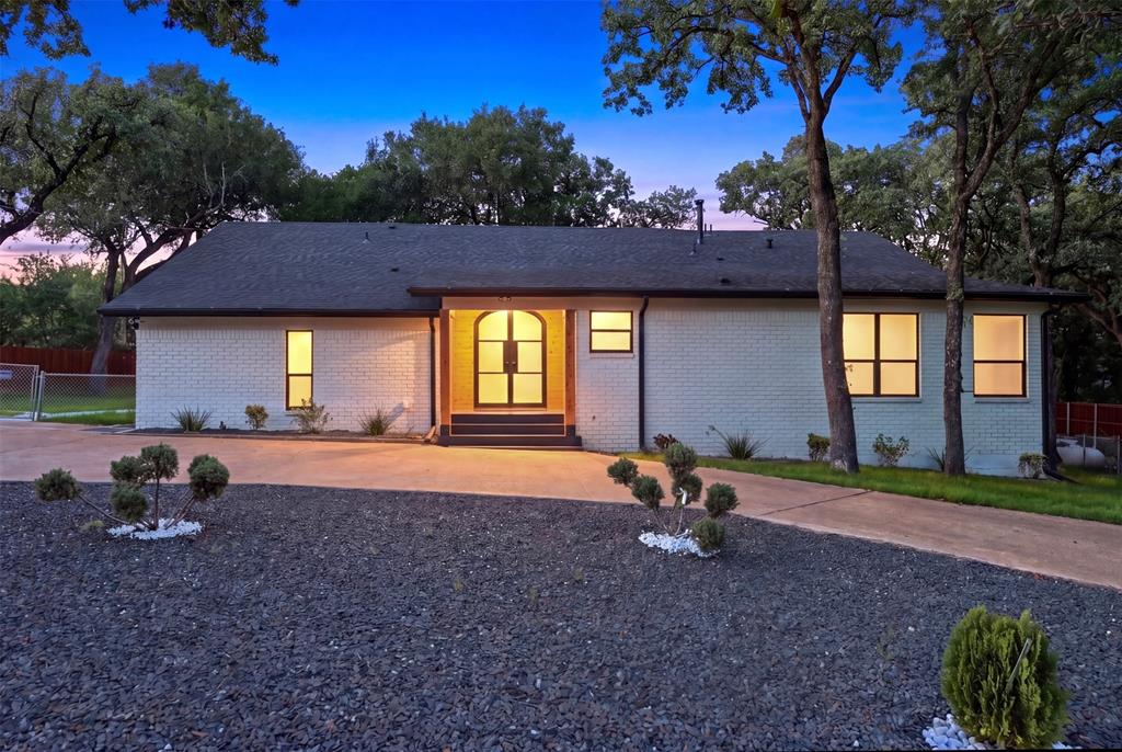 SELLER FINANCING! Tucked away on a private, tree-covered acre in Keller, this fully reimagined estate delivers the kind of lifestyle buyers rarely find in today’s market modern luxury, usable land, and the freedom to live, work, and entertain without compromise. From the moment you arrive, the architectural presence stands out. The freshly redesigned exterior, dramatic entry, and mature canopy of oak trees create a setting that feels elevated, secluded, and unmistakably custom. Inside, the home blends clean contemporary finishes with warm, inviting spaces designed for both refined entertaining and comfortable everyday living. Expansive windows frame the natural surroundings while filling the home with light. The open layout flows seamlessly to multiple outdoor living areas, including an oversized covered patio and elevated deck overlooking the property. Whether hosting guests, enjoying quiet evenings under the trees, or creating your own backyard retreat, this property offers the space and flexibility to make it your own. What truly separates this estate is the land and functionality. In a market where usable acreage in Keller is increasingly rare, this property delivers a full acre with endless potential. The detached shop building provides exceptional versatility for car enthusiasts, hobby space, storage, a home business setup, or future customization opportunities. Every detail of the property reflects thoughtful updates, timeless design choices, and the kind of privacy that luxury buyers are actively searching for. And while the setting feels tucked away from everything, you’re still just minutes from Keller’s premier shopping, dining, schools, and major commuter routes. This is more than a remodeled home on acreage it’s a private luxury retreat that offers space, flexibility, and a lifestyle that’s becoming nearly impossible to replicate in Keller.