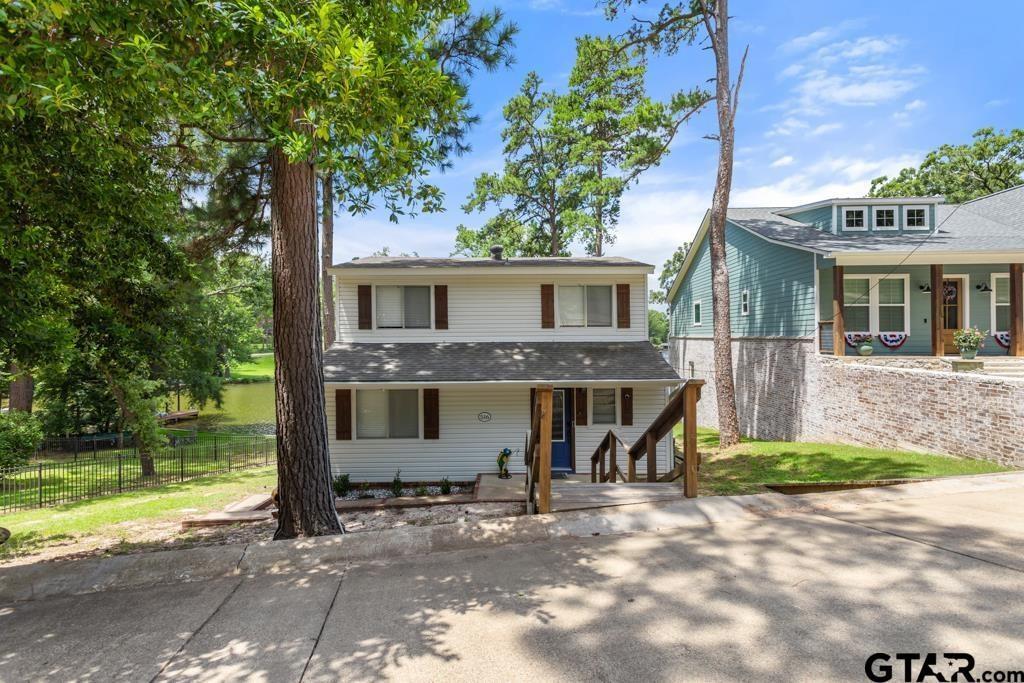 Beautiful Lakefront Home in the Gated Hideaway Lake Community that won't break the bank! Welcome to this move-in-ready lakefront retreat located on the desirable Third Lake in the private community of Hideaway Lake. This charming home features a double-deck boat dock—perfect for relaxing evenings while taking in stunning sunset views over the water. Inside, you’ll find a spacious laundry utility room and a thoughtfully designed kitchen. The open-concept living and dining areas offer soaring ceilings, making them ideal for entertaining or simply enjoying lake life with family and friends. The cozy living room includes a wood-burning fireplace, and a charming reading nook offers the perfect spot to enjoy your morning coffee. The main level features a generously sized primary suite with a walk-in closet and a private bath. Upstairs, two comfortably sized bedrooms share a full bathroom—perfect for guests or family. This lake house comes furnished with living room and bedroom furniture as well as the washer, dryer, refrigerator so you can start enjoying your new home right away. Don’t miss the opportunity to own this hidden gem—schedule your private showing today!