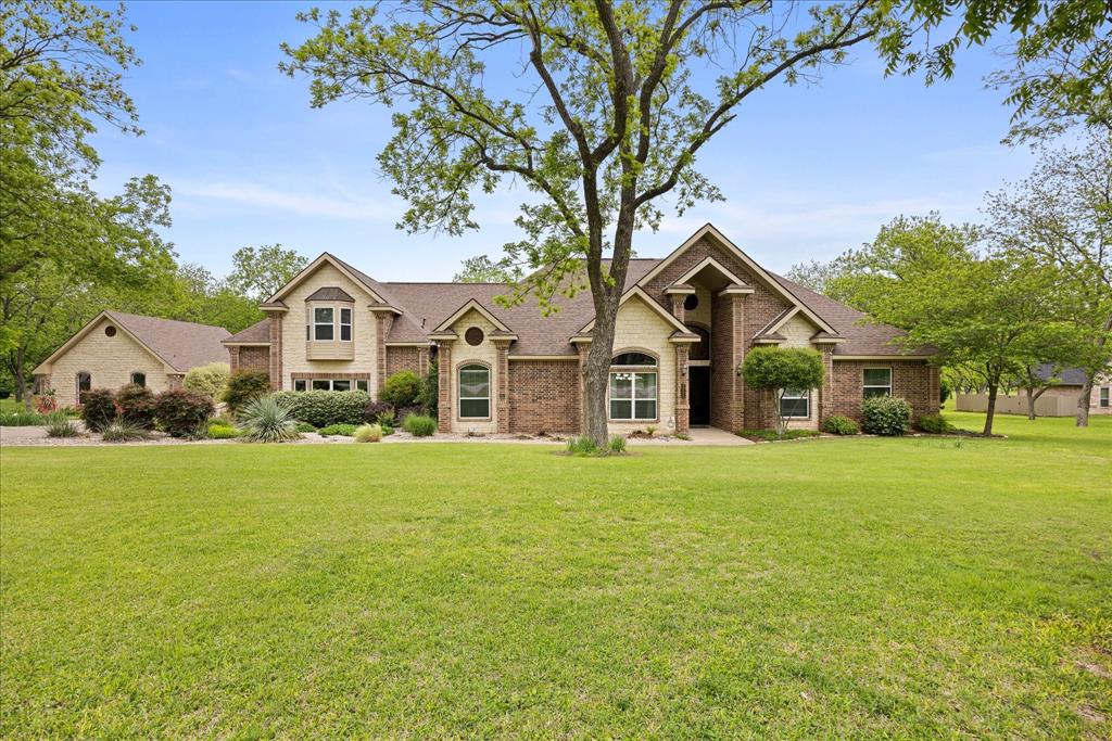 Hurry...this beautiful estate home in the highly sought after Retreat neighborhood of Pecan Plantation will not last! This impeccably maintained home boasts 4 bedrooms, 3 full bathrooms, 3 living areas, 2 dining areas, plus an office and large laundry room. The kitchen cooktop and the laundry room are double plumbed so you can use electric or gas in those areas. There are 2 bedrooms downstairs and 2 bedrooms upstairs as well as a bonus space that could be a game room, play space, or additional home office. The home was built with steel stud framing, providing increased durable and resistant to fire, wood rot, mold and termites plus offers perfectly straight walls. The Icynene spray foam insulation is eco-friendly and is known for its air-tight, energy efficient benefits that significantly lower utility costs. Roof was replaced in 2024 with a Class 4 shingle, which will provide a discount with most insurance companies. The backyard is private, has a pool and spa, built in 2019 and is enclosed with an aluminum and privacy fence. The property is surrounded by beautiful pecan trees and a lush, manicured lawn. There is a detached shop measuring 28x40, that includes a half bath and loft storage that could be used as a shop or finished out for additional living space and includes a 30-amp plug. The home is located on a quiet cul-de-sac, conveniently close to the front gate of the neighborhood. Pecan Plantation offers many amenities including parks, marina, clubhouse, golf courses, restaurants, air parks, stables, archery range, campground, VFD and 24-7 EMS, medical clinic, pharmacy, veterinarian, grocery store, activity center, pools and tennis. Guard gated community with security. Minutes from the historic Granbury Square on the Fort Worth side of town.