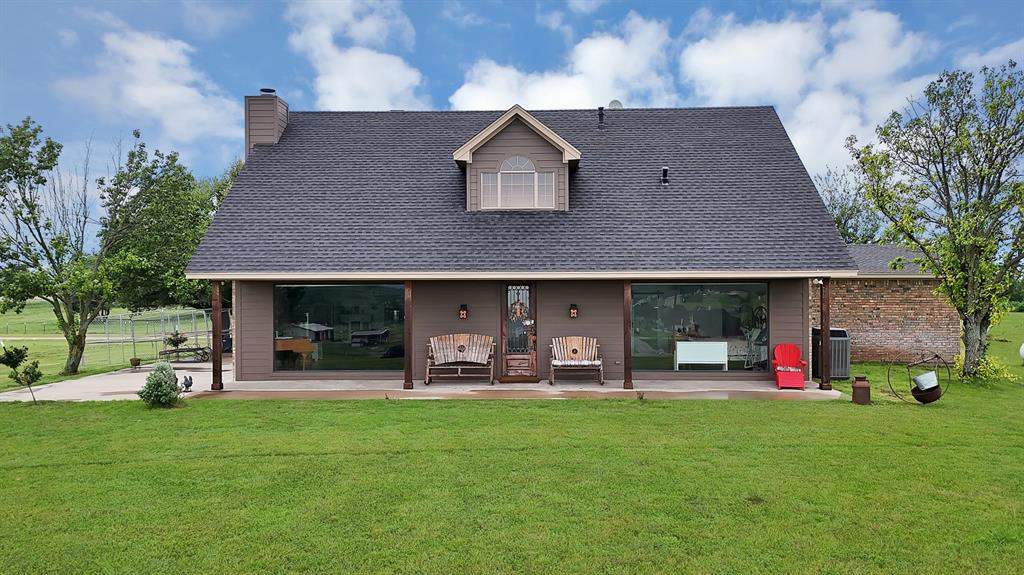 Experience the ultimate in Texas country living with this stunning estate nestled on 9 acres. This property offers an unparalleled sense of openness and tranquility, situated atop a hill to capture breathtaking panoramic views through massive picture windows that flood the home with natural light. The heart of the home is an open-concept living area featuring beautiful wood-look flooring and a cozy stone fireplace. The kitchen is a standout, boasting granite countertops, a functional center island, rich wood cabinetry, and a spacious walk-in pantry. Retreat to the primary suite, a private sanctuary complete with a luxurious ensuite bathroom featuring dual sinks, a large garden tub, and a separate walk-in shower. For those needing additional space or multi-generational living options, the property includes a separate dwelling unit, perfectly designed as a mother-in-law apartment with its own kitchen and living facilities. Car enthusiasts and hobbyists will fall in love with the massive detached workshop and garage. This oversized facility provides multiple bays, a car lift, and significant covered parking. Outside, the expansive grounds are perimeter fenced with barbed wire, making it an ideal setup for horses. Enjoy quiet evenings on the covered front or rear porches while taking in the serene landscape of your private retreat.