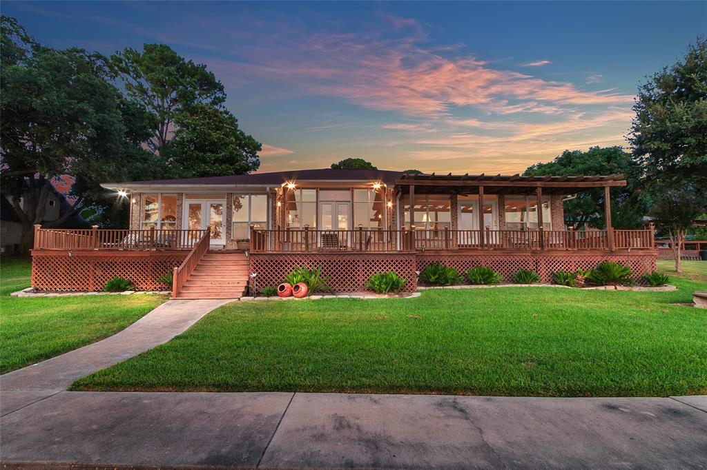 Savor the quiet magic of Cedar Creek Lake's most spectacular sunset views. This elegant home, set on 120 feet of deep, wide open yet protected water, epitomizes lakefront living. Renovated with upscale designer touches, the open floor plan flows seamlessly for entertaining while it's soaring ceilings and large windows frame million-dollar views. The gourmet kitchen boasts a 6-burner Wolfe gas range, Sub-Zero fridge, custom cabinetry, granite countertops, and a huge walk-in pantry. A bar connects to the game room, with 2 living rooms offering ample space for gatherings. French doors open to wraparound decks, with a pergola for sunny days and a lakeside patio for sunsets. 3 fireplaces add warmth year-round. An office off the formal living room provides a quiet workspace. The primary suite includes a sitting area, double walk-in closets, and a luxurious ensuite bath. The home also has two additional bedrooms and baths, and a garage guest suite creates a 4th Bedroom with privacy for guests. The 2-slip boat dock is a bonus for friends arriving by boat. A recent refresh included exterior paint on house, garage and boat dock and additional landscaping.   Imagine ending every single day with breathtaking golden hours right on Cedar Creek Lake. No HOA, VRBO allowed.