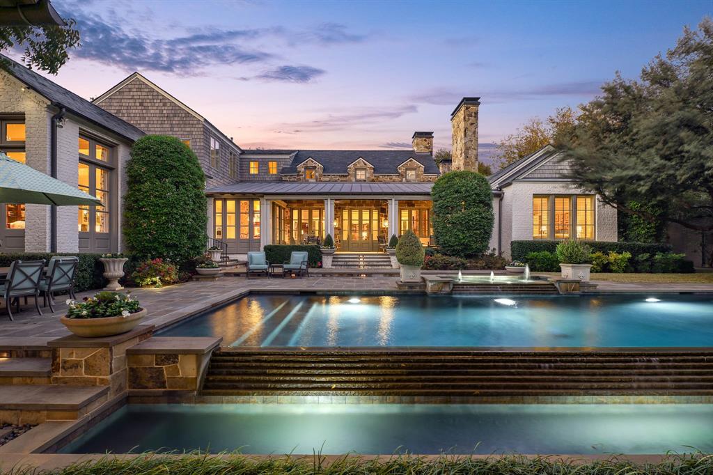 Nestled on one of old Preston Hollow’s most prestigious streets, 5722 Park Lane offers 7,998 square feet of refined living with timeless architectural detail and thoughtful design. The home features spacious formal living and dining rooms, along with inviting family spaces. A chef’s kitchen anchors the heart of the home, opening seamlessly to casual living and entertaining areas. The first-floor primary suite is complete with a spa-inspired bathroom and expansive his and hers closets. The first floor features an additional bedroom with an en-suite bathroom. Three additional bedrooms upstairs are generously sized providing flexibility for family and guests. Outdoors, the property features a large screened in porch, sparkling pool, and covered cabana ideal for year-round entertaining and relaxation.