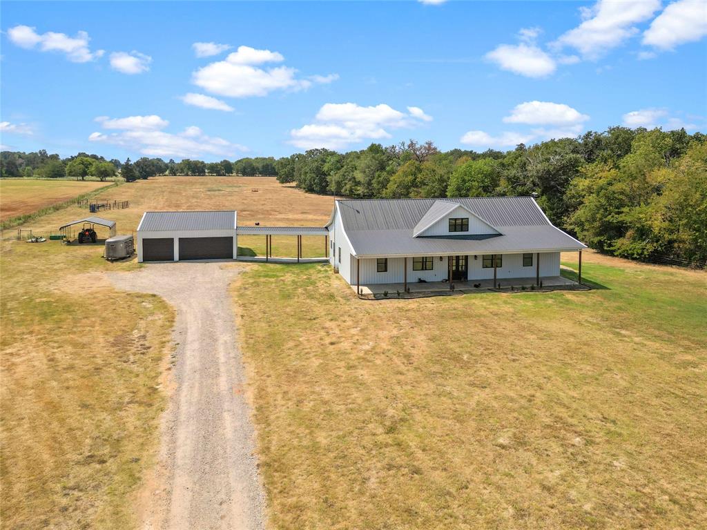 **$7,500 seller concessions with Full price offer**Welcome to this stunning 2021 farm house barndominium that seamlessly combines charm with modern elegance. Situated on 15 acres of picturesque land, this property offers serene contemporary living. Step inside and be greeted by a thoughtfully designed open-concept layout that enhances the sense of space and connectivity. The kitchen is a culinary enthusiast's dream, featuring a large central island that serves as both a functional workspace and a gathering point for family and friends. With five generously sized bedrooms, there's ample space for a growing family or accommodating guests, plus an office that can double as a 5th bedroom. The master suite is a private retreat, complete with an en-suite bathroom that boasts modern fixtures and finishes. For those with a penchant for hobbies or a need for extra storage, the detached three-car garage offers ample space to cater to your needs.