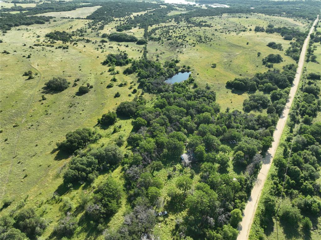 The Tolliver Estate is a legacy 601-acre ranch located just south of Hico in northern Hamilton County, offering a rare combination of productive pasture, rolling terrain, and exceptional recreational potential. With over 6,600 feet of frontage on CR 293 and multiple gated entrances, this property provides easy access and privacy, making it ideal for a weekend retreat, working ranch, or long-term investment.


The land features elevation changes from 1,080 to 1,240 feet, creating scenic hilltop build sites with sweeping views. A mix of beautiful hardwood timber—Post Oaks, Live Oaks, and Elms—frames the landscape alongside brushy draws and native grass pastures. Several small stock ponds are already in place, and the natural topography and watershed offer excellent potential for small lake development. The ranch includes three water wells with electricity, one of which is reported to produce over 100 gallons per minute. A large metal shop with a slab foundation and sliding doors provides functional workspace and storage. Two sets of working pens with barns and sheds support livestock operations, while two old homesteads with historic barns, windmills, and weathered structures add character and a sense of history to the property.


There are also two improved grass fields in need of mesquite clearing, but full of promise. The entire property is surrounded by mostly large neighboring ranches, with no nearby development encroaching on the peace and seclusion. While the Tolliver Estate could use some TLC and cleanup, it holds all the right ingredients to become a premier livestock and recreational ranch, offering a unique opportunity to own a true piece of Texas with strong potential for future development or a lasting family legacy.