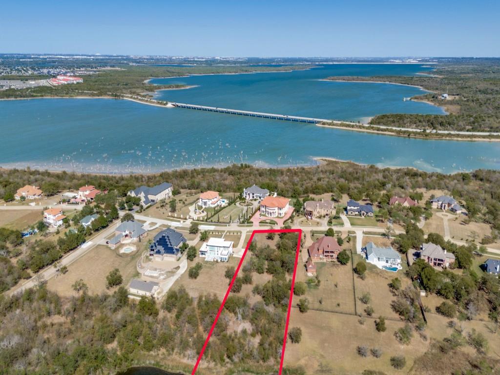 Build your dream home on this prime 1.54-acre homesite in the prestigious Lake Ridge community near Joe Pool Lake. Surrounded by luxury custom estates, this property offers the perfect balance of elegance, privacy, and convenience. With usable terrain and tranquil pond views at the back, the setting is ideal for your custom design, pool, and outdoor living spaces.  Enjoy all that Lake Ridge POA offers—Tangle Ridge Golf Club, an 18-hole championship course, plus parks, playgrounds, and walking trails. Conveniently located near shopping, dining, hospitals, and entertainment, with quick access to major highways—24 mi to DFW Airport, 17 mi to AT&T Stadium, 16.7 mi to Globe Life Field, 21.5 mi to downtown Dallas, and 30 mi to downtown Fort Worth.  Bring your own builder and start creating your luxury retreat today!