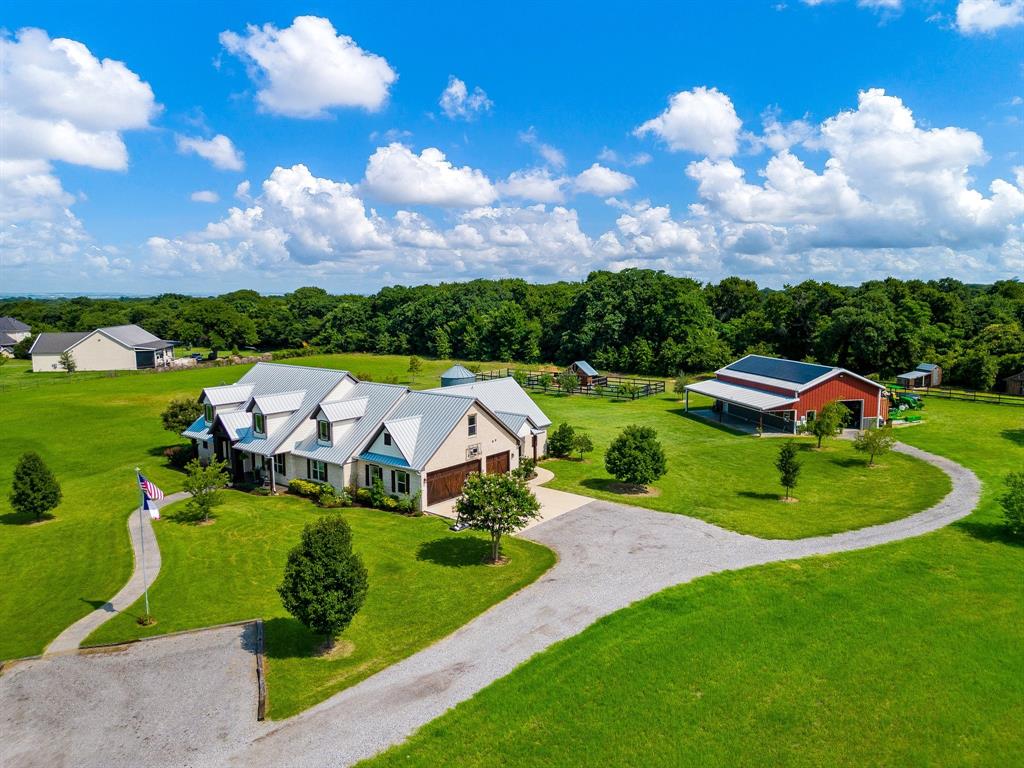 Welcome to your Paradise Resort with endless features on a private road with a pond! Extensive floorpan with guest home! Walk in to reclaimed hardwood floors, tall ceilings, beautiful built in woodwork throughout! A well thought out kitchen built for a chef, knotty alder cabinets, real Copper fixture and pot filler, impressive Connoisseurian range, Libharr German Fridge, and lookout to a stunning saltwater pool! Peaceful and serene property inside and out! Separate owners suite, private office. Pool with diving rock, spa, large covered porch, fire pit, garden with 20 producing fruit and nut trees, 1815 sq feet workshop, Class IV lifetime Metal roof with Tesla solar panels and backup battery! Guest quarters with a wonderful layout, full size kitchen, living, bedroom and full bathroom! Well water is 1,000 feet deep, conventional septic and solar panels, providing your own utilities! AG exempt for Hay! Soil is ideal for livestock, layout has ample space for events.