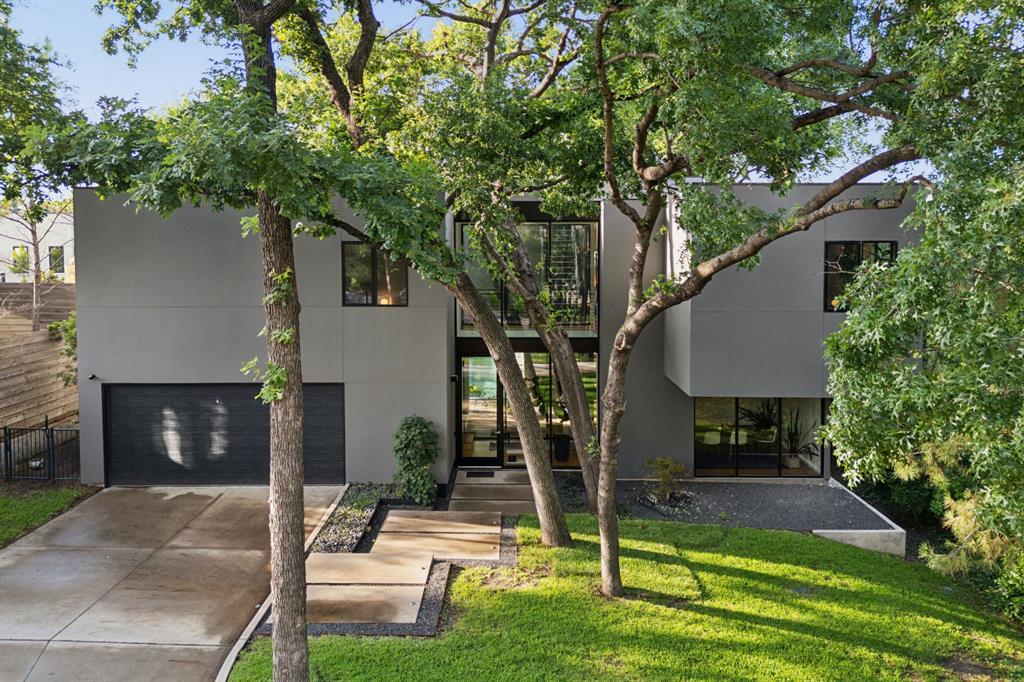 Come home to this Luxury estate with gated entrance and private grounds in one of Dallas' most sought-after neighborhoods! The house is surrounded by mature trees allowing for indoor-outdoor living. Dappled light through the canopy floods the home with soft glows that change during the day. This one-of-a-kind house was recently built in 2019 and was carefully designed for practicality while enjoying all of the modern conveniences. The first floor consists of an open living concept with designer kitchen, commercial grade appliances and separate pantry. Dining room and spacious living room provides for entertaining and access to the covered patio, private fenced yard and 60-ft heated lap pool. The connecting garage includes space for two oversized vehicles, Tesla charging station and built-ins for storage needs. There are 4 bedrooms with ensuites on the second level. The primary suite is generous with separate walk-in closets, a sitting area to watch the sunrise and it's own private covered balcony for coffee with the squirrels and birds. The primary bathroom has a soaking tub, dual sinks, and walk in shower with heated floors. There is also a laundry room with sink, built in cabinets and LG Signature Washer and Dryer. The home is wired for technology, including managed access points, Lutron's Homeworks, powered blinds, audio, video, and security system in a hidden room. Walk out to the roof top deck and experience the Dallas Skyline and nature on the 1,300 SF patio with large firepit and outdoor kitchen for all of your entertaining needs. This property is conveniently located to walking & biking trails, stevens park golf course, tennis courts and close proximity to Bishop Arts District, Uptown and Downtown.
