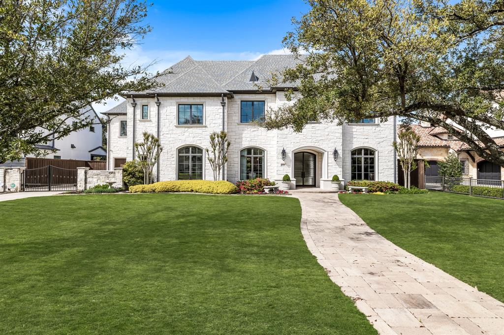 Nestled on a wonderful block in Preston Hollow, this 2015 masterpiece by Thomas Signature Homes unfolds over 7,563 sq ft of classic elegance, offering 5 bedrooms (with primary and guest suites on the main level), 6.2 baths, and bespoke living spaces including a game room, media room, study, and exercise room, which could be a 6th bedroom. Built on a generous 100 x 188 lot, the property showcases a beautifully turfed and landscaped backyard, complete with a patio featuring electronic screens for year-round enjoyment. The traditional style home seamlessly blends luxury with functionality, featuring a 3-car garage and meticulous attention to detail throughout. This home not only provides a lavish lifestyle with its private and entertainment-ready spaces but also situates itself as a coveted gem in the heart of Preston Hollow, promising a unique blend of sophistication, comfort, and elegance.