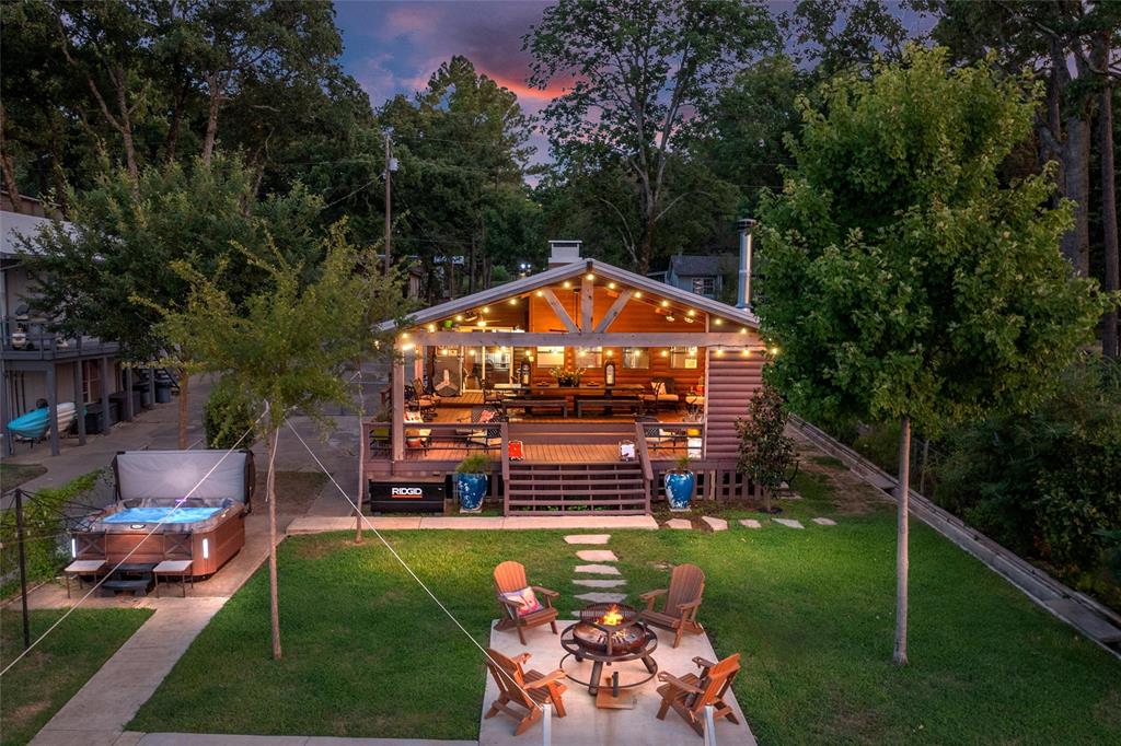 Charming lakeside log cabin with miles of open water views. This inviting retreat features a spacious living area with vaulted wood ceilings and a stunning stone-tile fireplace accented by a granite hearth. The light-filled kitchen offers stainless steel appliances and an abundance of windows, allowing you to enjoy breathtaking lake views while preparing meals. The home includes two bedrooms, two beautifully updated bathrooms with designer touches throughout, plus an additional sleeping loft. Outdoor living is exceptional with a huge covered porch featuring a stone fireplace and space for outdoor television viewing, creating the perfect setting to relax, entertain, and enjoy the beautiful waterfront scenery year-round. Additional outdoor amenities include a lakeside patio with stairs leading directly into the water, providing easy access for swimming and lakeside fun. The boathouse features a boat slip and a separate watercraft lift, making it easy to enjoy boating, fishing, and all the recreational opportunities the lake has to offer. Whether you're seeking a weekend getaway or a full-time waterfront retreat, this charming log cabin offers the perfect blend of rustic charm, modern comfort and exceptional lakefront living.