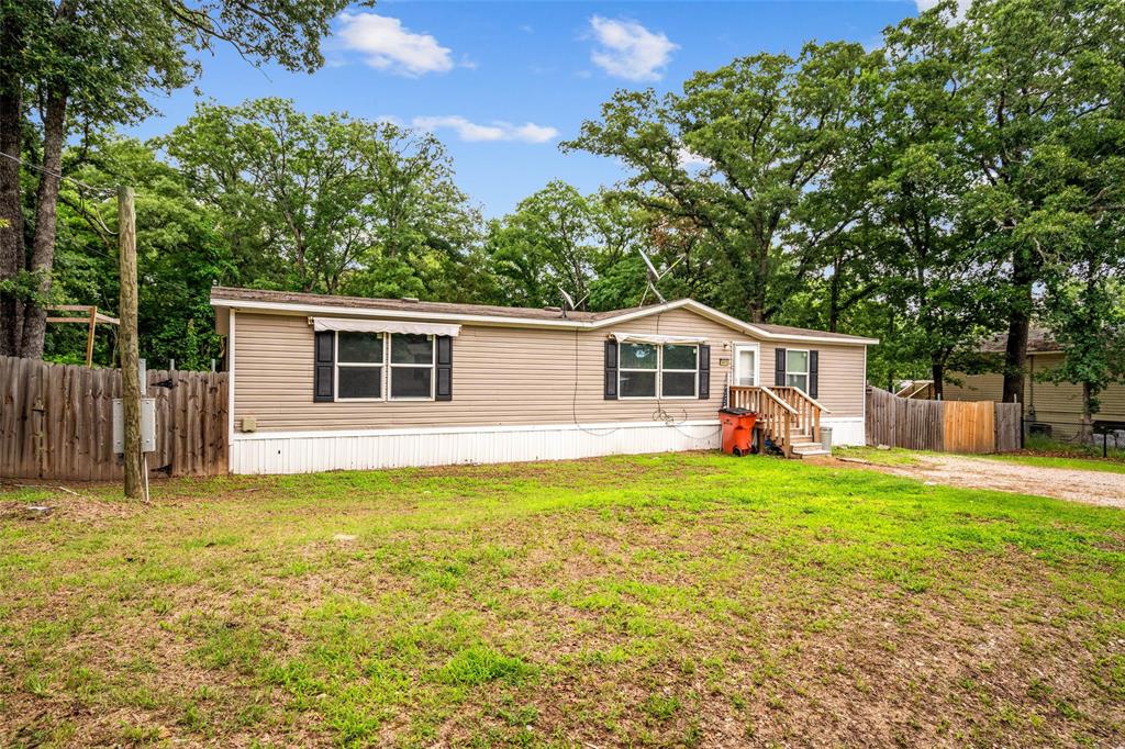 Newer 3-bedroom, 2-bath manufactured home located just one street from the lake. This well-maintained home features a desirable mother-in-law floor plan with a spacious primary suite separate from the secondary bedrooms. The primary bedroom offers a private ensuite bath and ample closet space.

The open-concept layout provides a comfortable flow between the living room, dining area, and kitchen. The eat-in kitchen includes a center island, abundant cabinet storage, and plenty of counter space for meal preparation and entertaining. A full-size laundry room adds convenience and additional storage options.

Outside, enjoy the large fenced backyard complete with a covered deck, storage shed, and a small garden area. The backyard offers plenty of room for pets, outdoor activities, or future landscaping projects.

Conveniently located near local restaurants, coffee shops, fast food and grocery stores while still offering a peaceful residential setting, this property combines functional living space with outdoor amenities. Whether you're looking for a full-time residence or a weekend retreat near the water, this home is ready for its next owner.