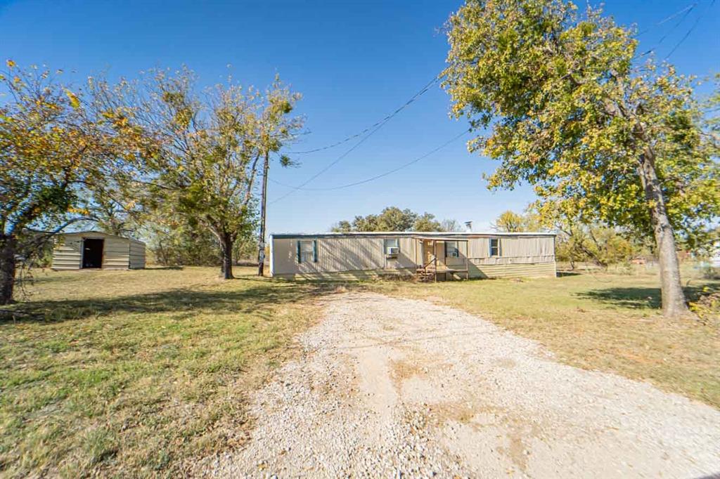 Partially renovated home on 3 lots with shop.  Great fireplace not seen often on this type of home  Multiple possibilities! Finish out the mostly completed renovations or use the spacious 3 lots to build the home of your dreams on.  Quiet neighborhood and close to all the comforts of town.