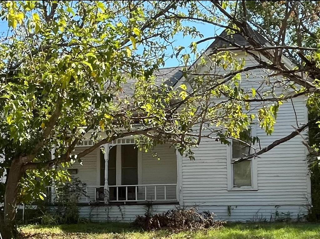 Charming fixer upper with a storybook front porch, a huge lot, and tons of potential right on Farmersville's historic main street. Located an easy walk from downtown shops and restaurants, and just blocks away from all four of the Farmersville schools, this classic beauty is just waiting for someone with vision and creativity to restore her to her former beauty. This could be a stunning home or the perfect investment property, it just needs some love.
