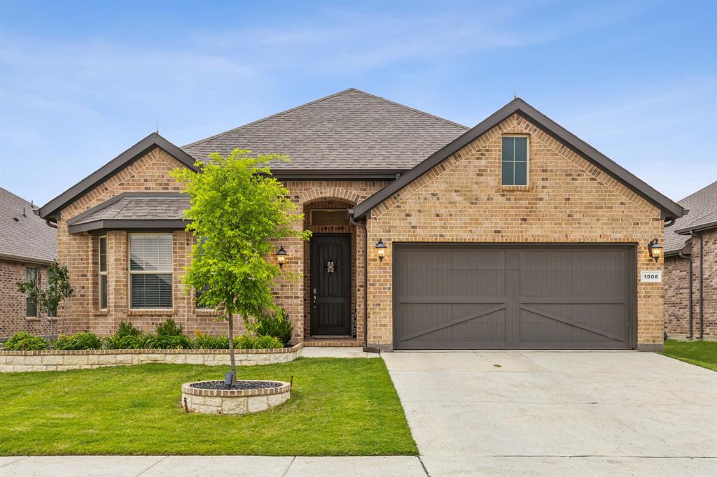 Experience elevated living in this meticulously upgraded home where exceptional curb appeal, professionally designed landscaping, and custom stone-edged flower beds create a striking first impression. The bright open-concept floorplan offers expansive living, dining, and entertaining spaces enhanced by extensive wood-look tile flooring, custom designer lighting, a striking linear fireplace with bespoke trim detail, and a built-in mud bench. The chef-inspired kitchen is a true showpiece featuring quartz countertops, 42-inch cabinetry, custom wood vent hood, designer backsplash, oversized island, pot-and-pan drawers, built-in stainless steel appliances, gas cooktop, walk-in pantry, and separate hutch-bar area ideal for entertaining. Retreat to the private primary suite complete with a luxurious ensuite bath and spacious walk-in closet. Additional highlights include epoxy garage flooring, smart home technology, ceiling fans throughout, and an energy-efficient tankless water heater. Enjoy outdoor living under the covered patio overlooking the large grassy backyard with ample space to play or unwind. Ideally situated near the community pool, park, and playground with convenient access to major highways, shopping, dining, Historic Downtown Denton, Texas Motor Speedway, and Tanger Outlets Fort Worth.