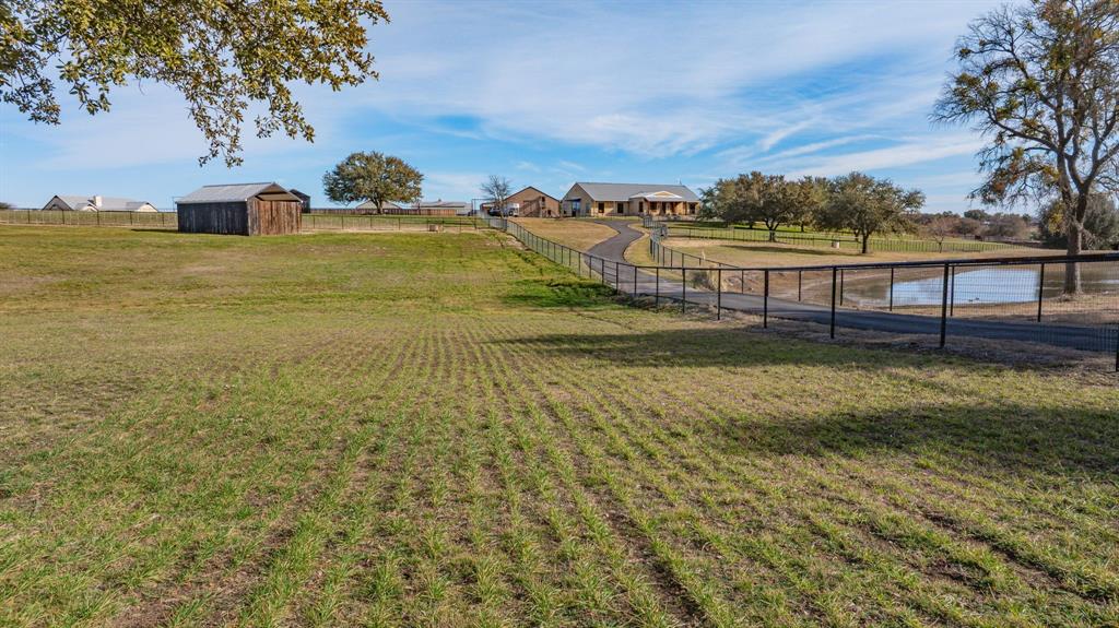 Silverado on the Brazos truly has it all — refined country living with convenient access to Weatherford, Granbury, and Fort Worth. This exceptional equestrian estate spans 18 acres in the highly sought-after Silverado on the Brazos community and is thoughtfully designed. Ideal for trainers, or serious horse enthusiasts. The property features a custom-designed, rustic-finished 1-bedroom, 1-bath, 688 sq ft Barn dominium, a 120’ x 120’ arena, a premium Trojan 60’ panel walker, and a 60’ round pen for additional training space. The land is fully fenced and cross-fenced with pipe no-climb fencing, offering excellent functionality and safety. Eight well-appointed turnouts, each equipped with 16’ x 30’ loafing sheds and automatic water, provide outstanding pasture management. Income-producing opportunities include three additional on-site apartments, ideal for staff housing or rental income. The ranch is further supported by a 10,000-gallon holding tank, ensuring reliable water capacity year-round. Additional improvements include a state-of-the-art 88’ x 40’ horse barn with eight 14’ x 12’ stalls, a feed room, tack room, and wash rack with mare stocks. A spacious 40’ x 60’ hay barn with ample storage completes the working infrastructure.This turnkey equestrian facility offers rare scale, functionality, and versatility in one of Parker County’s premier horse communities — just minutes from Weatherford with easy access to Fort Worth.