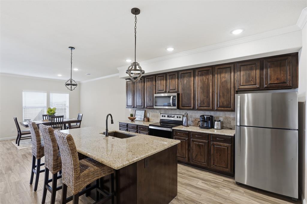 Welcome to 1100 Noble Flair, a spacious and well designed 3 bedroom, 2.5 bath townhome offering 2,502 sqft on a desirable corner lot in the Acton school district of Granbury ISD.

The open concept main living area is filled with natural light and anchored by a stone fireplace, flowing seamlessly into the dining space and kitchen. The kitchen features granite countertops, abundant cabinetry and a large island that works for both daily living and entertaining. Upstairs you’ll find generously sized bedrooms including a spacious primary suite with dual vanities and a walk-in shower, along with a second living area that offers flexible space for a media room, office or playroom. Additional highlights include a 2 car garage, keyless entry smart lock on the half glass front door and a dedicated laundry room complete with built in cabinetry and countertop workspace. Step outside to a private fenced backyard, while the HOA covers lawn maintenance for easy, low maintenance living. This home also offers a unique level of flexibility. It can be purchased fully furnished including washer, dryer, refrigerator and household items or vacant depending on buyer preference. Whether you’re looking for a primary residence or a turnkey opportunity, this home delivers both space and convenience in a great location.