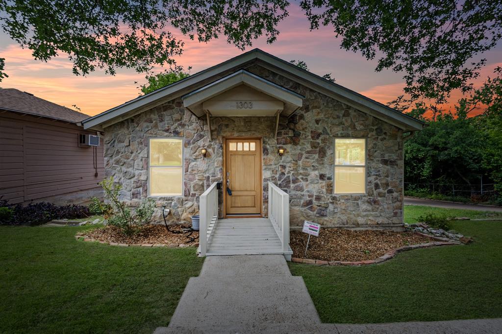 This timeless Austin Stone bungalow home is the queen of the subdivision sitting pretty on a large corner lot in the beautiful sought out Cedar Oaks Neighborhood! With warm, jewel-toned stonework on the exterior, this 3 bedroom, 2 bathroom home has been thoughtfully renovated while maintaining some of the loveliest aspects of the original home. Large brand-new windows with custom up down window coverings look out onto the lush green oasis of the Dallas Zoo property, you will love the view from these windows! The spacious kitchen with granite countertops is the heart of the home opening to the living area. Custom quilt pieced floor in the bathroom, along with walk in closet in the primary suite. Two car garage with additional room for storage, and long driveway with plenty of room for quest parking! Enjoy a highly walkable, picturesque neighborhood famous for its free-range peacocks that frequently make their rounds in daily visits. This property sits just a short stroll from Halperin Park, the newly opened $300 million Deck Park built right over I-35 and the Dallas Zoo. An incredibly central location means you are just minutes away from Downtown Dallas and top-rated options like Trinity Heights Gifted & Talented, Travis Vanguard, and Townview Magnet Schools.