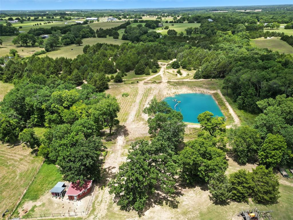Incredible 22+Acre Estate With Beautiful Sunsets Offers The Ultimate In Comfort, Functionality, And Sustainable Living! This Exceptional Property Features Custom Butcher Block Countertops, Stainless Steel Appliances, A Spacious Pantry With Barn Door, A Breakfast Bar, And An Inviting Eat-In Kitchen. The Utility Room Offers A Sink And A Second Pantry, Great For Extra Storage. The Living Room Features A Cozy Masonry, Wood-Burning Fireplace, Creating A Warm And Inviting Space. Add To That A Huge Game Room, Providing That Flexible Extra Space To Enjoy Whatever Your Heart Desires. Easy-To-Clean Laminate Hardwood Flooring Flows Throughout The Home, Keeping It Virtually Allergy Free. The Bedrooms Are Spacious, And The Covered Front Porch Is The Perfect Spot To Enjoy The Relaxing Country Views.  Extras In This Home Include A Full House Water Filtration System, Attic With Foam Insulation, A Newer HVAC System, And Solar Panels That Keep Utility Bills Exceptionally Low. Outdoors, You’ll Find A Nearly One-Acre Pond, Hiking Or Biking Trails, Goat Or Calf Shelters With Fencing, A 500 Square Foot Chicken House, And Two Large Outbuildings. One Is 720 Square Feet With Both 30 Amp And 50 Amp Service For Easy RV Hookup. The Other Is 884 Square Feet With Two 12-Foot Doors And An Unfinished Bathroom Area, Offering Incredible Flexibility. Enjoy The Peace And Privacy Of Wide-Open Spaces, Breathtaking Sunsets, And Plenty Of Room For Horses, Livestock, Gardening, Or Recreation. This Bonham Gem Is Truly A Rare Find For Those Seeking A Spacious, Self-Sufficient Lifestyle With Room To Spread Out And Thrive! Ask About The 2-1 Buydown Available!