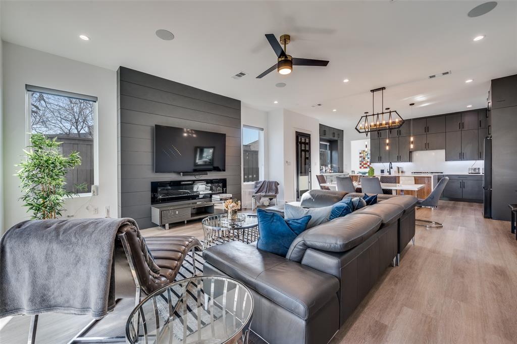 Experience modern luxury located near Uptown and the Medical District. This striking three-story residence features 4 bedrooms, 4.5 bathrooms, and thoughtfully designed spaces for both comfort and entertaining. The expansive gourmet kitchen showcases sleek stainless-steel appliances and ample workspace, perfect for culinary enthusiasts. Enjoy effortless indoor-outdoor living with 10 private balconies and a spacious backyard large enough to accommodate a pool. The bright and open living room offers stunning panoramic views of Uptown’s skyline, while the elegant dining area provides the perfect setting for gatherings. The second floor features two luxurious primary suites, each with oversized showers, freestanding soaking tubs, and impressive city views. On the third floor, you’ll find two additional bedrooms, two bathrooms, and an oversized roof-deck-style balcony ideal for relaxing or entertaining. High-end finishes throughout—including custom shades, quartz countertops, double vanities, and a dramatic 72-inch fireplace—create a sophisticated and stylish retreat designed for contemporary living.