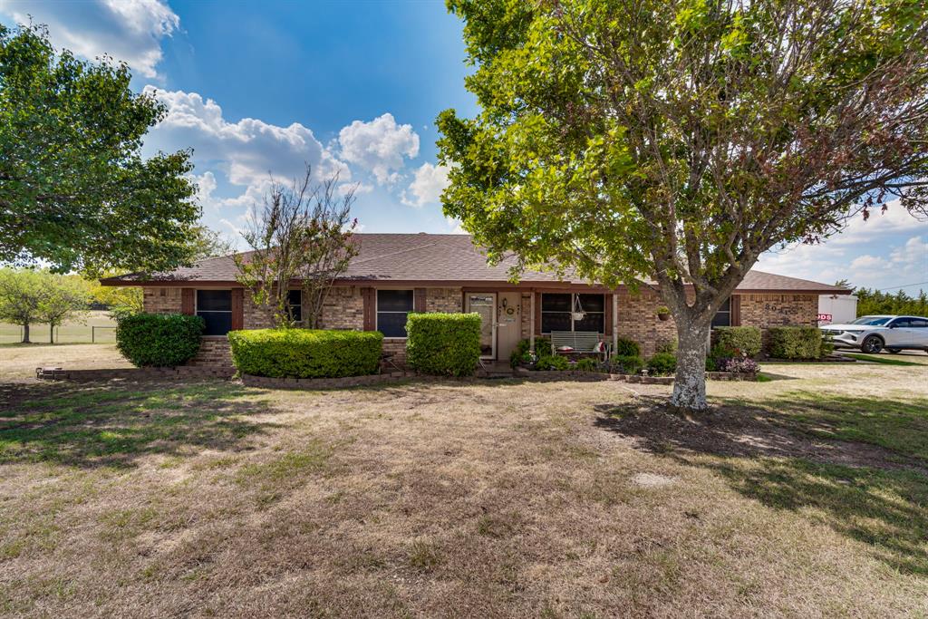 Don't miss this opportunity, 2+ acres with a view for miles. Enjoy fall sunsets on the screened in, covered patio overlooking your very own slice of country. This home features 3 bedrooms, a large recently updated eat in kitchen with custom cabinets and solid surface counter tops, a 
 large formal dining room and huge family room with fireplace ready for all the family to enjoy. Also featured are beautiful custom hardwood floors throughout common areas, carpet in the bedrooms, large utility laundry area with huge storage room pantry area. Ample storage building for all your lawn equipment, etc. Room for all the kids and animals and still easy access to Hwy 287and Hwy 67.