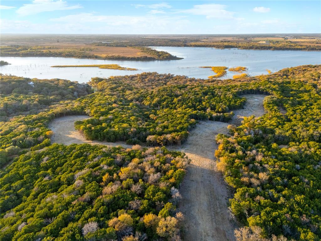 Exceptional Lake Waco property in the City of Woodway offering a rare combination of privacy, flexibility and long-term value. This sprawling wooded tract features spectacular lake views and access, mature oak trees, creeks, pond, and an abundance of wildlife. The property is easy to navigate with multiple access points off Poage Drive, Harbor Drive, and Shadow Mountain. City of Woodway utilities are available with up to 65 water meters and a City of Woodway approved development plan allows for multiple use options, including a private family compound, single-family ranch estate or multi-lot, single-family residential development. Located within an established upscale neighborhood, this property offers exceptional versatility for both end users and developers. Midway ISD. Survey and Geo Study Available. Listing agent must be present for the initial showing. Pre-Approval required.