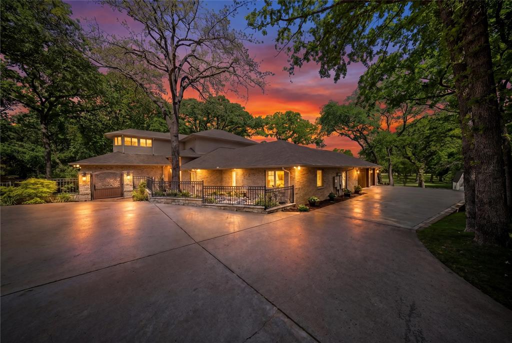 An extraordinary opportunity to acquire a 5.16-acre Colleyville luxury estate • 6,881 total AC SF • Guest house • Pool-spa • Outdoor kitchen • Multiple Bars • No HOA • Over $600K in documented improvements. Designed for estate-scale entertaining and multi-generational living, this unique estate features a 5,978 sq ft main home and a 903 sq ft guest house on a wooded cul-de-sac. The 5.16-acre setting backs to Big Bear Creek and includes a courtyard connection between main-guest house, six garage spaces, mature trees, and greenbelt views. Inside, major improvements elevate the finish-out: Panda Marble, quartzite, hardwoods, custom cabinetry, designer lighting, wrought-iron French doors, and AV-home automation upgrades. Panoramic full-slider doors in the game room areas enhance indoor-outdoor living and open to meticulously landscaped grounds. The kitchen features a 15x6 island with Panda Marble, dual farmhouse sinks, Thermador-Wolf stainless steel appliances, double ovens, dual dishwashers, a professional cooktop and hood, a refrigerator, a microwave, an ice maker, and custom lighting. The bar-game room includes quartzite surfaces, modern mirror accents, wine refrigeration, wet-bar, commercial-style glass entry doors, and dedicated electrical service. Outdoor living is a highlight, with 2,000+ sq ft of patios and a large wood deck framed by lush greenery that screens neighboring sightlines. The grounds include a pool-spa, outdoor kitchen, stone fireplace, new decks, a bridge approach to the pool, a retaining wall, sprinkler updates, and additional landscaped areas. The dream guest house offers 6 sets of steel updated doors, Juliet balconies, utility connections, and serves as a flexible space for extended stays, private work, or separate living needs. Located in the highly acclaimed Grapevine-Colleyville ISD near Market Street, Starbucks, Life Time, City Park, and Colleyville Library. Don’t miss seeing this unique estate! Agent to meet for all showings with POF.