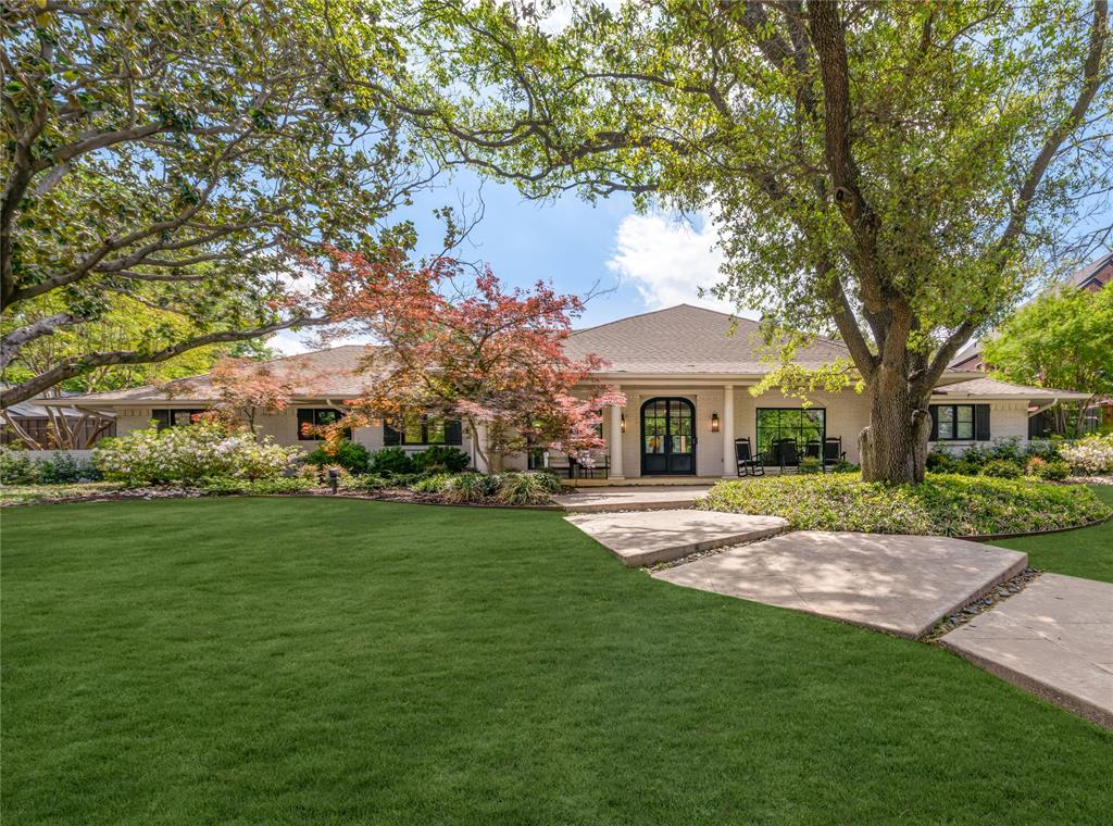 Situated on a highly desirable street in the Windsor Park neighborhood of Preston Hollow, this updated single-story Southern retreat sits on an oversized 115x145, heavily treed lot. Offering over 4,000 sq ft of beautifully curated living space, this charming ranch-style home has been extensively improved with fabulous upgrades since 2021, blending timeless character with modern updates. A light-filled entry welcomes you into spacious formals and a large den with a redone fireplace and walls of doors overlooking the backyard oasis. The updated eat-in kitchen features stainless steel appliances, a walk-in pantry, redone wet bar, and an enhanced breakfast or study area—perfect for everyday living and entertaining. The home features 5 bedrooms, 4.1 baths, and a generous game room that opens to the turfed backyard. The oversized primary suite overlooks the pool and includes an updated bathroom and dual primary closets for a true retreat experience. Step outside to your private backyard featuring an oversized patio, a pool that has been recently resurfaced with new equipment, a turf backyard with ample green space for entertaining and play, and a new gate. Additional highlights include replaced windows, spray foam insulation, newer HVAC, replaced front door, custom built-ins, updated baths, updated sprinkler system, and more. This move-in ready home offers exceptional indoor-outdoor living on a premier lot, with convenient access to major highways, NorthPark Center, and premier dining.