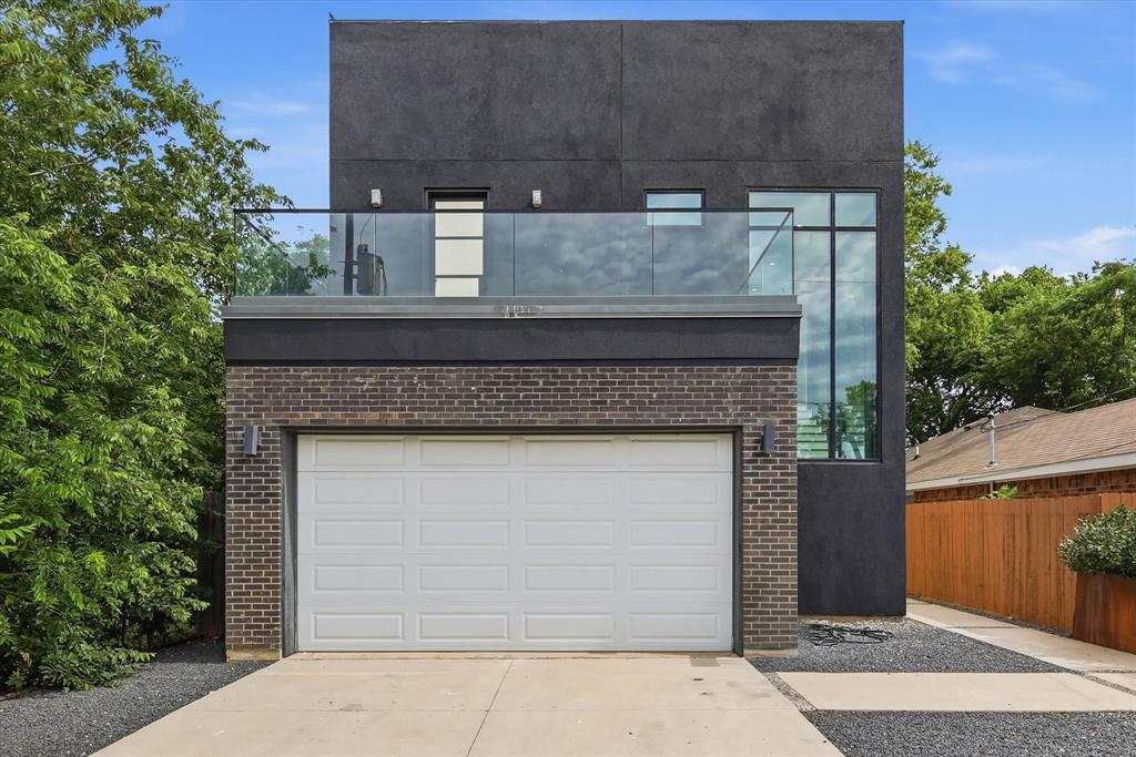 Architect modern design in Trinity Groves offered at $535,000 with seller offering $5,000 seller incentives. True two story home with 2,442 sq ft featuring garage, chefs kitchen, living, laundry, and half bath on main level, plus 3 bedrooms and 2 full baths upstairs.

Open concept living anchored by dramatic floor to ceiling concrete plaster feature wall with custom electric water vapor fireplace and matching vent hood. Kitchen features waterfall Calacatta quartz island seating 4, full height white European cabinetry, dark marble backsplash, under cabinet lighting, gas range, and stainless French door refrigerator, all conveying.

Floor to ceiling black framed glass with approximately $100k replacement value and sliders with blackout drapery open to covered concrete rear patio with full outdoor sectional, mature 7 ft magnolias, white Rose of Sharon shrubs, and $3k custom shed. Primary suite offers private rear balcony, massive walk in closet with custom built in organization system, blackout drapery, freestanding soaker tub, frameless glass shower with marble inlays and bench, dual Calacatta veined quartz vanities, separate water closet, and large format porcelain.

Front bedroom includes second private balcony and custom built in Murphy bed with bookshelves configured as office guest room. Third bedroom bright and flexible with ceiling fan. Real hardwood upstairs, wood look porcelain downstairs. Fully foam insulated verified in 2023 purchase docs, 6 inch thick perimeter walls, full stucco exterior, rain gutters with guards, split AC per floor, custom iron door with black restucco on upper patio, brand new water heater, $6k garage gym flooring, and $1k EV charger.

Over $30k landscaping includes custom Corten steel garden boxes, mature holly hedges, sprinklers, drip irrigation, fully fenced yard with dual gates, and dog door in laundry. Just 5 minutes from Downtown Dallas.
