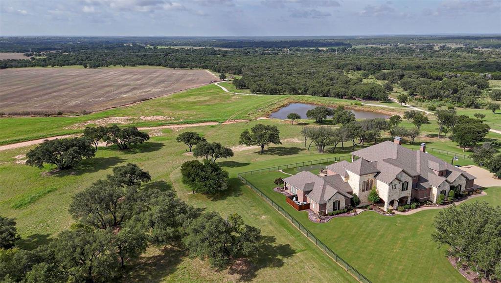 466.52 Acres in Jonesboro, Texas..Coryell County . nestled within  the picturesque ranch lands of Jonesboro, Texas. Shipley River Ranch is a distinguished 466.21 acres estate offering a harmonious blend of natural beauty, rich ranching heritage, and convenient access to key metros including Waco, Dallas and Austin. The ranch's terrain captivates with 120 feet of elevation change, unveiling expansive vistas, rolling pastures, and rich tapestry featuring almost a mile of winding Leon River frontage, wooded ridges, seasonal creeks and lush pecan bottoms. Improvements & residence: Custom Built 7022 SF, two story stone and brick masterpiece. Five bedrooms, six full baths and two half baths., Grand foyer with winding staircase. An elevator near the laundry room offers optional second story access. Formal dining area featuring expansive windows overlooking the grounds. Gourmet kitchen with top-tier GE Monogram appliances(gas range, double door refrigerator,double oven,,dishwasher, warming drawer, wine cooler).over-sized island offering and breakfast nook opening to the outdoor patio. Spacious living living area with built-in bookcases, gas fireplace, and seamless access to outdoor kitchen, swim up bar, dual fireplaces (gas and wood) and putting green. Luxurious primary suite with soaking tub, walk in shower, large walk-in closet housing a safe room and adjoining private exercise room opening to the patio and pool area. Additonal bedroom with en-suite bath on main living level. Upstairs boast a large media and game room with full bar and access to an expansive covered deck, plus 3 bedrooms each with full baths. The three car garage with floor to ceiling cabinetry, epoxy floor, mudroom and oversized laundry, office storage. Views of live oaks, manicured lawns and landscaping provide shade and serenity from every natage point. Guest House includes an updated 3 bedroom, 2 bath residence originally built in 1947, remodeled in 2014