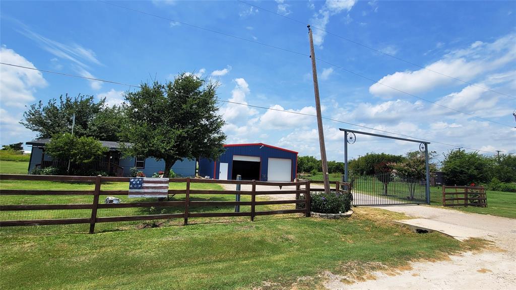 Experience the Pace and Quiet Charm of Texas Country Living on this lovingly maintained Home Pride doublewide home, nestled on a beautiful 1.17-acre lot shaded by mature trees. This sweet country retreat offers the peace, space, and freedom you've been looking for—perfect for relaxing, working, or raising a family.  Central heating and air are both electric.  8x15 Front porch and covered deck patio 42x12 —both ideal spots to soak in fresh country air.  Large metal workshop (approx. 40' x 35') sits on a solid concrete slab and is fully powered—ideal for DIY projects, equipment storage, hobbies, and much more. 
The main entrance gate is electric and remote-controlled, offering both convenience and added security. For those with a love for fresh eggs or farm life, there's also a charming wooden chicken coop in the backyard.
Located just 3 minutes (0.4 miles) from Venus Elementary School, this home is perfectly situated for families seeking convenience and a close-knit community.  Don’t miss this opportunity to enjoy the beauty and simplicity of Texas country living—schedule your showing today!