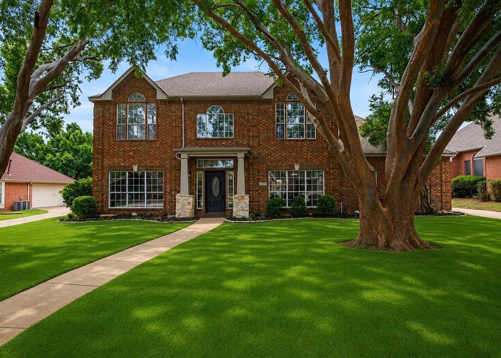 Discover refined living in this extensively renovated two-story traditional residence in Highland Village, offering almost 3,200 square feet of completely transformed living space where luxury, craftsmanship, and versatility shine. Thoughtfully redesigned with walls removed to create a more open, modern flow, this exceptional home has been reimagined from top to bottom with sophisticated upgrades throughout. Downstairs, a versatile flex room with a sleek fireplace, walk-in closet, and direct access to a beautifully renovated full bath offers incredible potential as a fifth bedroom, private guest suite, multi-generational living space, or game room. A dedicated home office near the entry adds even more flexibility. Fresh neutral paint, plush new carpet, and sweeping luxury vinyl plank flooring create a timeless, light-filled ambiance throughout the main level. At the heart of the home, the gourmet kitchen is a true showpiece, featuring custom solid wood cabinetry, elegant Quartz countertops, a professional-grade Aobosi 6-burner gas range with dual ovens, pull-out Zline microwave, decorative backsplash, spacious pantry, and designer finishes that blend beauty with function. Designed for entertaining and daily living, the expansive dining room flows seamlessly into the kitchen and living spaces. The living room impresses with a dramatic wall of windows and double glass doors that flood the home with natural light while creating a seamless indoor-outdoor connection. Upstairs, the expansive primary suite is a peaceful retreat with dual walk-in closets and a spa-inspired bath featuring Quartz counters, dual sinks, a freestanding tub, and a glass-enclosed shower with modern tilework. Three additional bedrooms share a stylishly updated full bath with dual sinks and contemporary finishes. Step outside to your private backyard oasis, where a spacious covered patio and mature shade trees create the perfect backdrop for relaxing or entertaining.