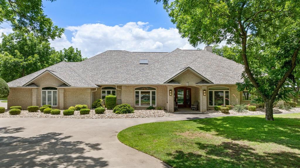 Rare opportunity to own a custom fly-in estate in the highly sought-after Air Park community of Pecan Plantation. Situated on approximately 1.18 acres, this beautifully maintained home offers the perfect blend of upscale comfort, functionality, and aviation lifestyle living.

Rare opportunity for aviation living with an attached insulated 50’ x 50’ private aircraft hangar featuring an oversized insulated 45’ x 12’ Wilson hangar door, dedicated RV door access, three private pedestrian entrances separate from the residence, direct taxiway access, and flexible space for a workshop, aircraft storage, or hobby area.

The spacious single-story residence offers approximately 3,822 square feet with 3 bedrooms, 3.5 bathrooms, multiple living and dining areas, a dedicated office with built-ins, and generous storage throughout. The gourmet kitchen is equipped with high-end appliances, abundant workspace, and custom cabinetry, creating an ideal setting for both everyday living and entertaining. The oversized primary suite features dual vanities, a separate shower, garden tub, and an expansive walk-in closet.

Additional highlights include a large 3-car garage, indoor pool, circular driveway, mature trees, and access to Pecan Plantation amenities including golf, clubhouse dining, community pools, parks, fitness center, tennis courts, and 24-hour gated security.

Experience the rare combination of established airpark living, upscale amenities, privacy, and everyday convenience in one of North Texas’ premier fly-in communities.