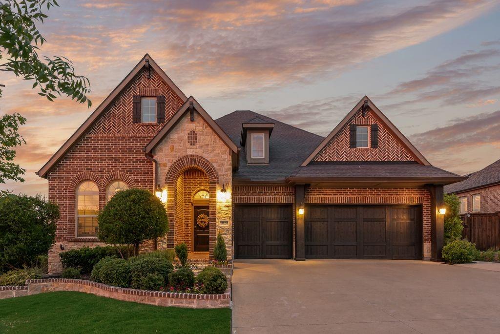 Nestled on over a third of an acre backing to a greenbelt in sought after Fairway Ranch, this stunning single-story home offers luxury living inside & out. Beautiful curb appeal welcomes you with a timeless brick & stone elevation, lush landscaping & a 3-car garage featuring charming wood garage doors. Gorgeous wood flooring flows throughout the bright open floorplan where expansive windows showcase serene greenbelt views & fill the home with natural light. The showpiece kitchen is designed to impress with white cabinetry, quartz countertops, a large seated island, gas cooktop with pot filler, double ovens, abundant storage & seamless flow into the dining area where additional built-in cabinetry & a wine cooler make entertaining effortless. The spacious living area with gas fireplace creates the perfect backdrop for gatherings both large & small. Relax in the luxurious primary suite featuring a sitting area with patio access & a spa-inspired ensuite bath complete with dual sinks, an oversized shower with body sprays & a walk-in closet with custom closet system. One of the three secondary bedrooms offers a private ensuite bath, ideal for guests or multigenerational living. Thoughtful design touches like high end wood accent walls in the primary suite & under breakfast bar plus custom woven wood blinds add style & function. Enjoy the backyard retreat where the extended covered patio features a fireplace & outdoor kitchen, creating the ultimate entertaining space. A cozy fire pit invites evenings spent talking under the stars & making s’mores while enjoying the oversized backyard & tranquil greenbelt backdrop. BONUS: A whole-home generator provides added peace of mind & convenience year-round. Residents of Fairway Ranch enjoy exceptional amenities including a community pool, playgrounds, fishing ponds, dog park, scenic walking trails & an in-community elementary school. Conveniently located near Highway 114 with easy access to shopping, dining, and entertainment.