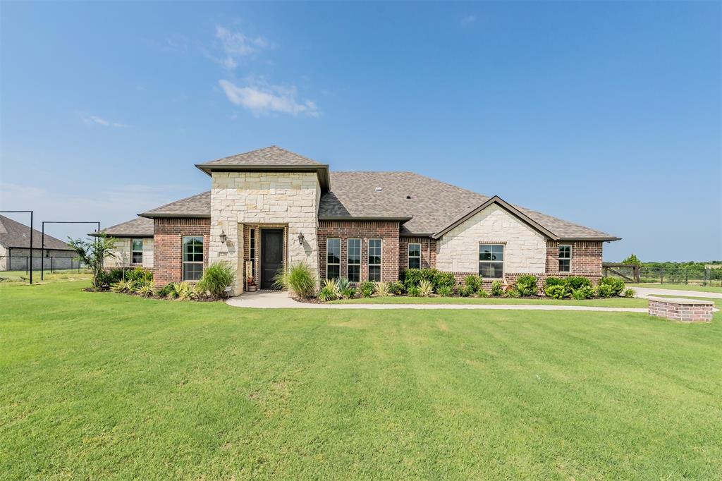Nestled on over 2 picturesque acres with breathtaking valley views, this beautiful one-story ranch-style home offers the perfect blend of comfort, functionality, and peaceful country living. With adjacent land protected by deed restrictions, you'll enjoy lasting privacy and uninterrupted views for years to come. The flexible floor plan features 4 bedrooms, 2.5 bathrooms, a dedicated office that can serve as a fourth bedroom, a media room or second living area, and a cozy breakfast nook. The inviting family room is anchored by a stunning floor-to-ceiling stone fireplace, while hardwood-look tile flooring, crown molding, abundant natural light, and recessed lighting create a warm and welcoming atmosphere throughout. The open-concept kitchen is designed for both everyday living and entertaining, offering a large center island, breakfast bar, custom cabinetry, granite countertops, tile backsplash, walk-in pantry, and seamless flow into the living and dining spaces. The spacious primary suite serves as a private retreat, featuring an electric fireplace with a wood mantel, ceiling fan, and a luxurious ensuite bath complete with a frameless glass tiled shower, garden soaking tub, separate vanities, makeup vanity, and walk-in closet. Additional highlights include a large laundry room with built-in cabinetry, an oversized garage extended approximately four feet for additional storage and workspace, a whole-house water softener and filtration system, private well, aerobic septic system, and an all-electric design. Outside, enjoy the covered patio, attractive brick and stone exterior, full gutter system, and a run-in shed ideal for livestock or agricultural use. Combining scenic beauty, thoughtful upgrades, and modern conveniences, this exceptional property offers the lifestyle you've been looking for.