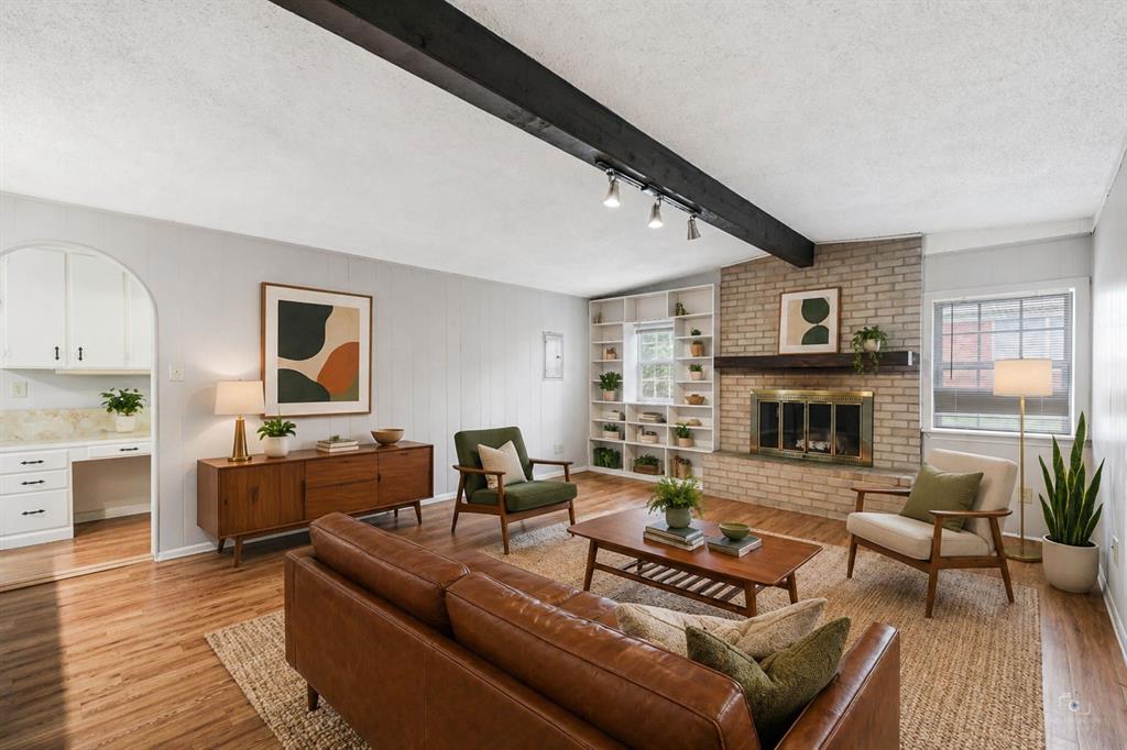 Mid –century vibe when you enter this charming 60’s home!  If you are looking for ready to move into home with a large fenced pool sized backyard, this property is worth viewing!  Lots of storage! Pella windows!  Gutters!  Wood Burning brick fireplace!  Covered Back patio and front porch, covered with an ideal mail slot in the front door!  No carpet!  Extensive vinyl and tiled floors!  Nice-sized foyer with traditional coat closet!  Two living areas!  Dining area opens to nice size kitchen and easy access to backyard!  Kitchen also offers an electric cooktop.  Built-in oven, microwave, dishwasher and disposal with plenty of cabinets and storage space.  Don’t miss the breakfast bar with additional under-cabinet storage!  Track LED lighting over the stainless sink opens to the second living area with an arched window, beamed ceiling and beautiful paneled walls and a fireplace with a mantle!   Additional uplighting above the kitchen cabinets opens to the first living area, which can certainly offer lots of options with this flexible floor plan!  Large laundry room with nice size pantry!  Central Gas heat!  Gas Water heater!  Gutters!  Three bedrooms and two baths!  Primary bedroom has built-in shoe shelves and ideal dual closet entry!  Lighted ceiling fans in all bedrooms!  Two-car garage with workbench, shelves, and peg boards.  Close to shopping, schools, restaurants and easy access to highways!  Established neighborhood with plenty of parking and wider streets.  No HOA!  Low tax rate!