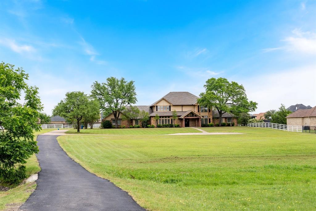 Rare opportunity! This stunning, completely renovated, privately gated 5-bedroom, 4.5-bathroom home sits on an expansive 5.36-acre lot, located just 20 minutes from downtown Dallas. Boasting incredible investment or multi-generational potential, the land can be subdivided into three separate parcels—perfect for building an additional family home or utilizing as you see fit. The acreage features a corral with plenty of open space for horses. Inside, the home has been beautifully updated with rich hardwood floors in the living and formal dining rooms, brand-new carpet in all bedrooms, and a fully remodeled kitchen featuring new cabinetry and all-new appliances. The main level offers an ideal, open floor plan: a huge formal dining room sits off the entry, leading into a spacious living room and a bright breakfast nook that opens directly to the kitchen. The thoughtfully designed layout places the massive primary suite on the east wing, complete with a luxurious, brand-new bath featuring a frameless glass shower and a standalone jetted tub. Nearby, a Jack-and-Jill setup connects two additional bedrooms with a shared bath. On the west wing, a private 4th bedroom features its own full bath and walk-in closet, making it an ideal in-law suite or home office. Located right off the breakfast area, the oversized laundry room features a convenient center island and a utility sink. Just beyond, you'll find the practical garage layout, split into a 2-car and private 1-car garage. Step outside to a massive entertainer's paradise featuring a large back patio with a brand-new outdoor kitchen, complete with granite countertops, a built-in grill, a beverage fridge, and a large sink—perfect for hosting 50+ friends and family. Upstairs, the home continues to impress with a massive media room complete with a wet bar alongside a spacious 5th bedroom with its own full bath. Also includes a freshly paved driveway and brand-new roof with 30-year shingles.