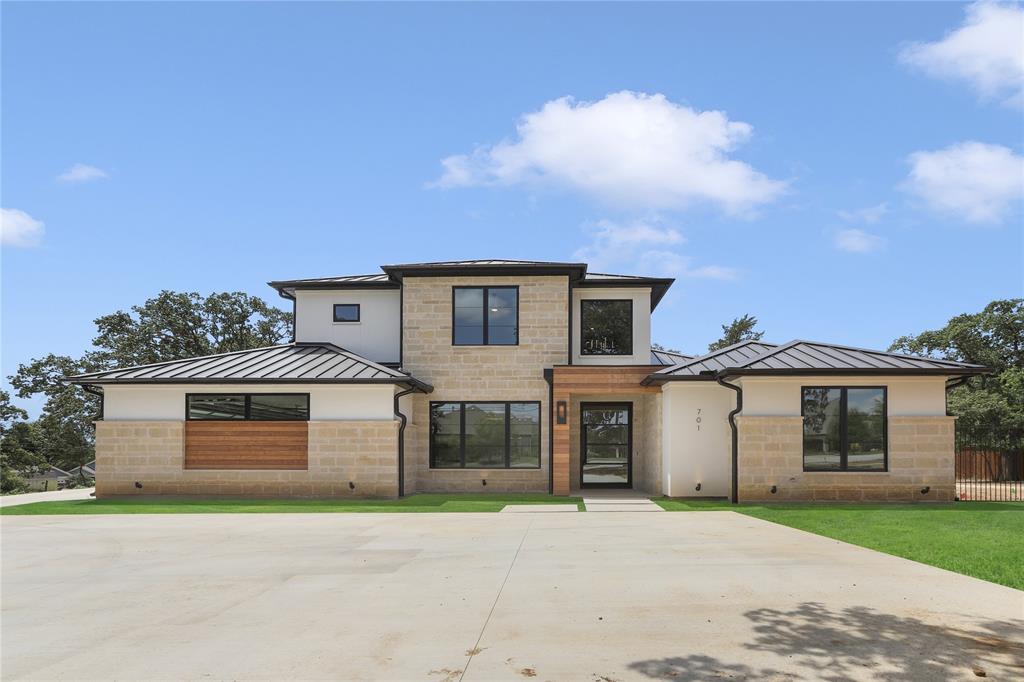 Sensational Modern Home sitting on a corner .71 Acre Wooded Estate Lot. No HOA's. The 5 Bed, 5 Bath Home offers Hardwood Floors Throughout & Light & bright open Concept living! The Main Living area offers 22 ft. Ceilings, Wood Beam Features & a Contemporary Fireplace, Bar, Wine Area, Gorgeous Chef's Kitchen offers Oversized Waterfall Island with Abundance of storage, Quartzite Countertops. Owner's Retreat offers, Luxe Ensuite w separate vanities, a walk-in shower, Hollywood Tub, large walk in Closet & Lighted Mirrors. Three Bedrooms Down w 2 upstairs Bedrooms & Gameroom. Additional 965 Sg Ft Outdoor Kitchen w Fireplace & Motorized Shades. The property can be used for a sports court or RV, Boat Garage. Home is zoned to Keller ISD schools with a GCISD transfer option. Amazing Find in Colleyville!